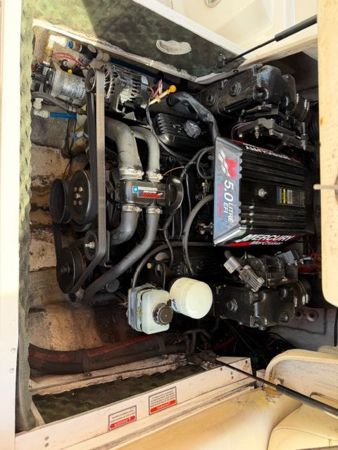 Engine compartment of a 2001 Sea Ray 210 Sundeck with visible engine and components.