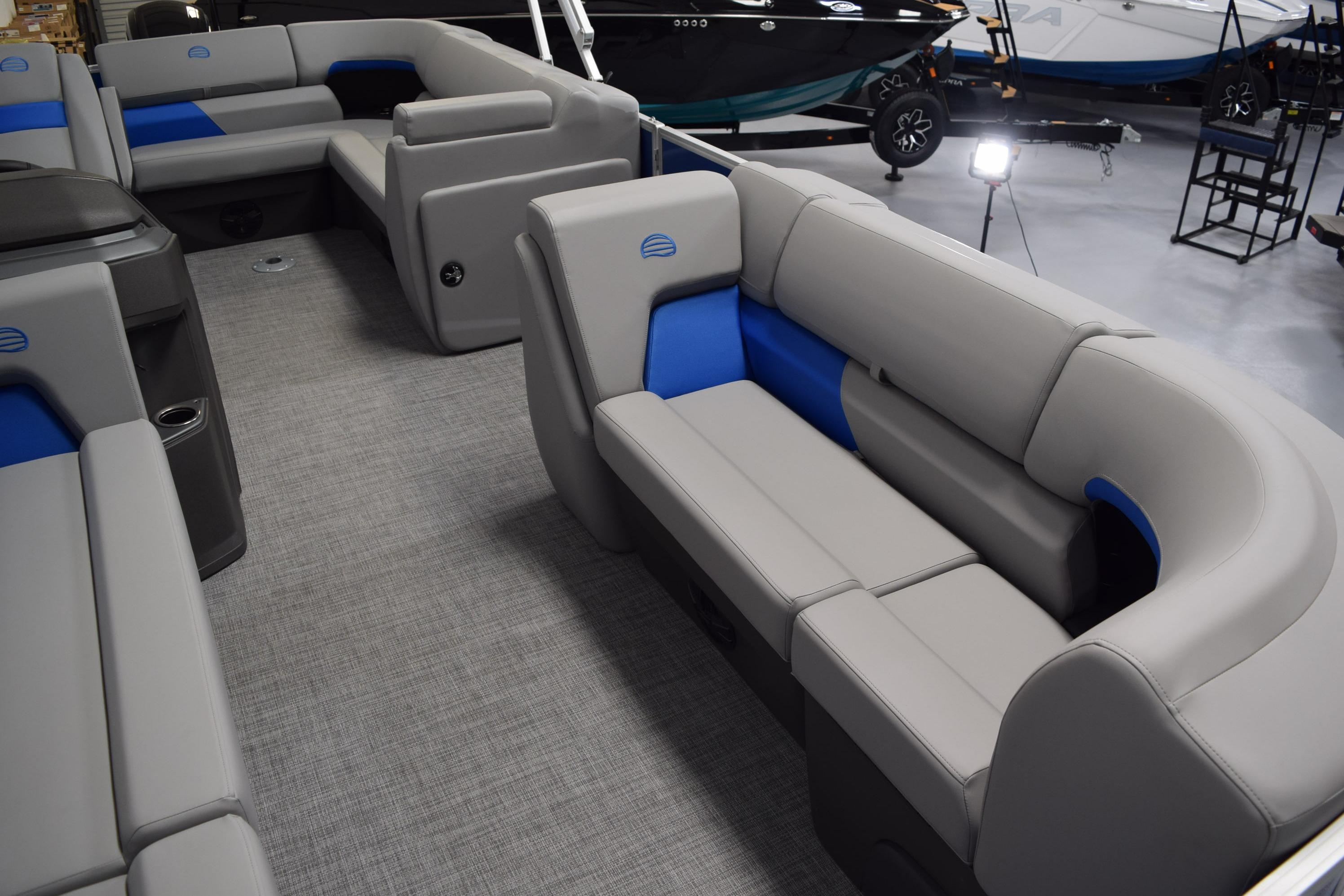 2026 Sun Tracker Party Barge 20 DLX interior with gray and blue seating.