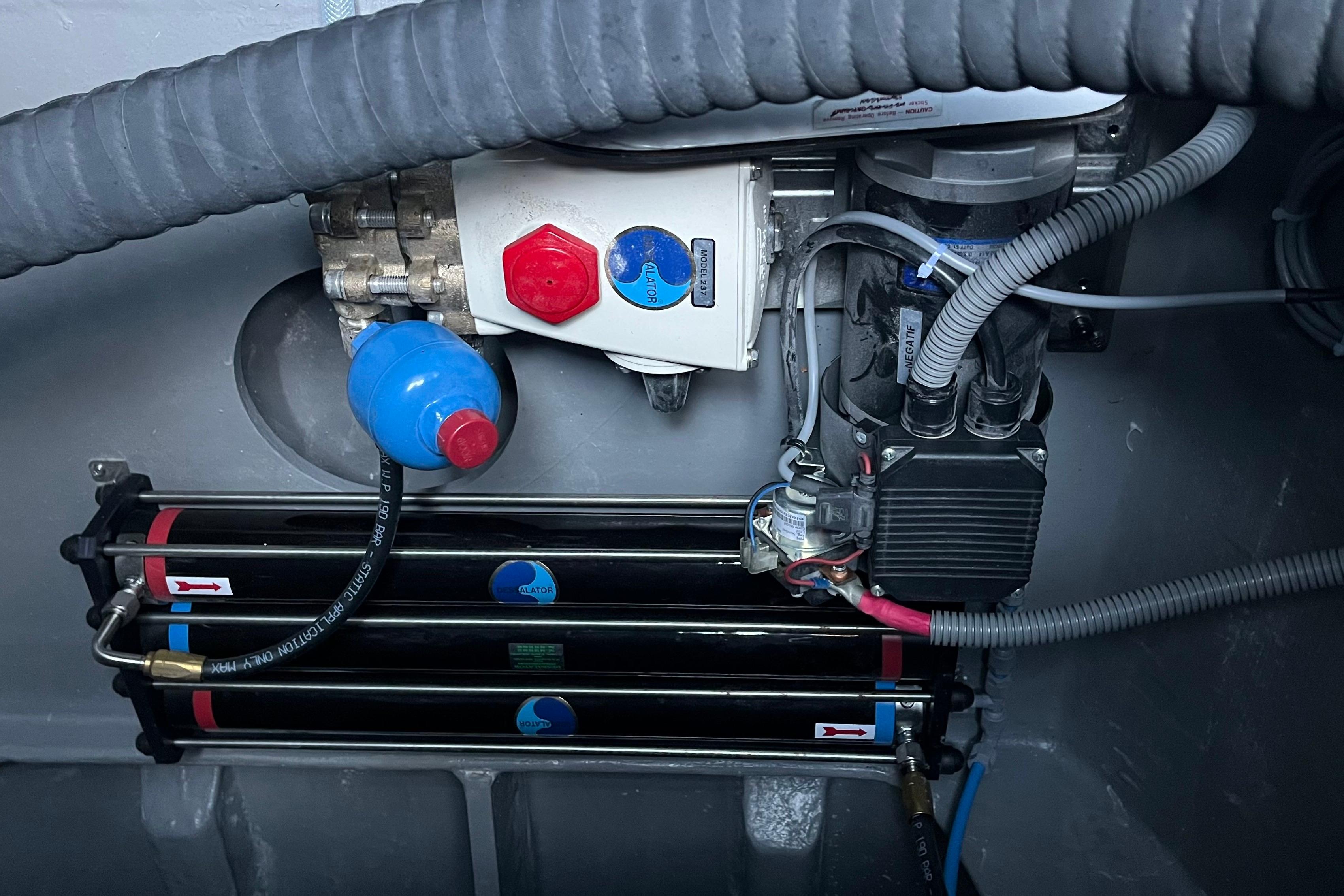 Engine compartment of a 2024 Outremer 45, showcasing mechanical components and wiring.