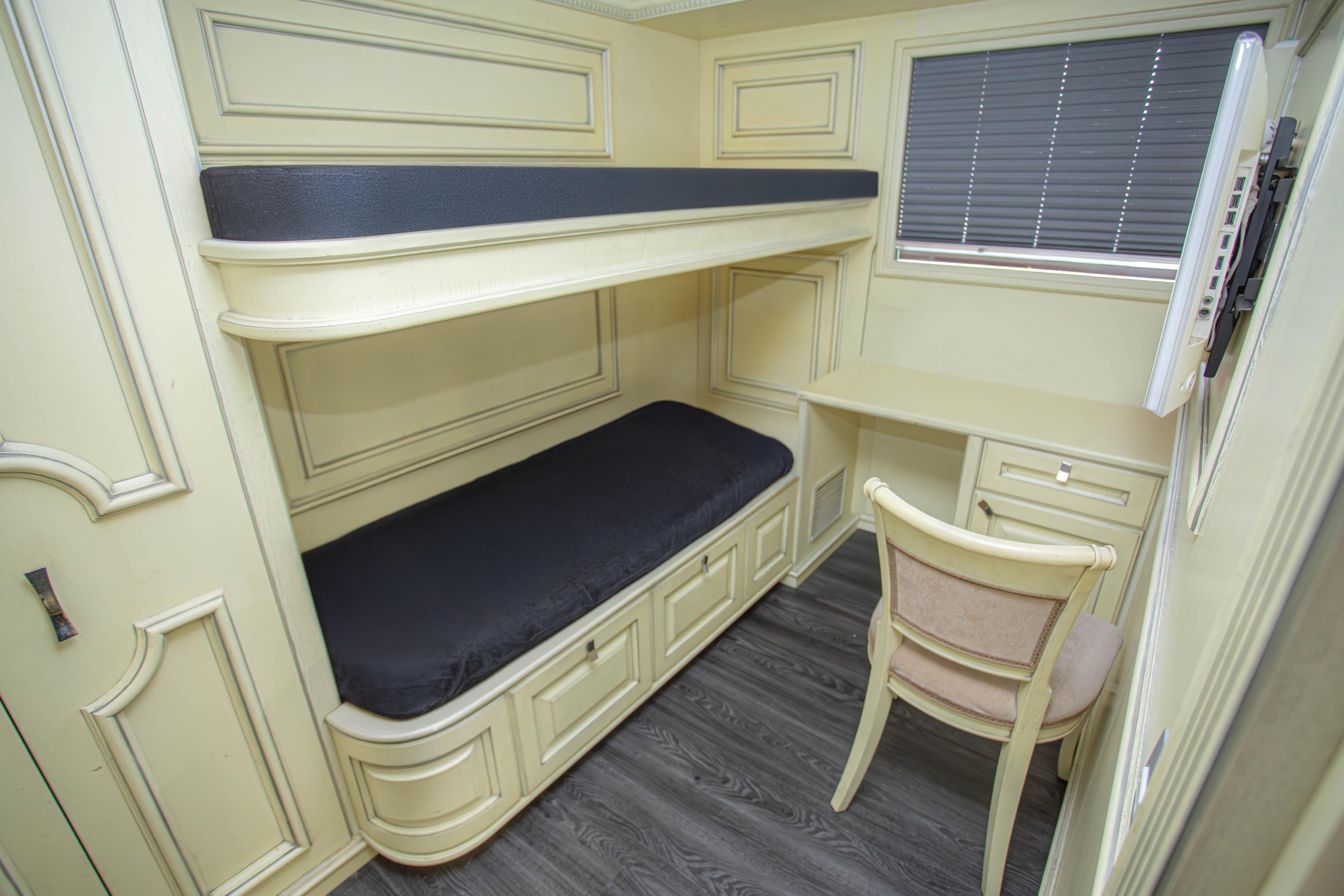 Compact cabin with bunk beds and desk on 2014 Fifth Ocean Yachts Explorer Yacht.