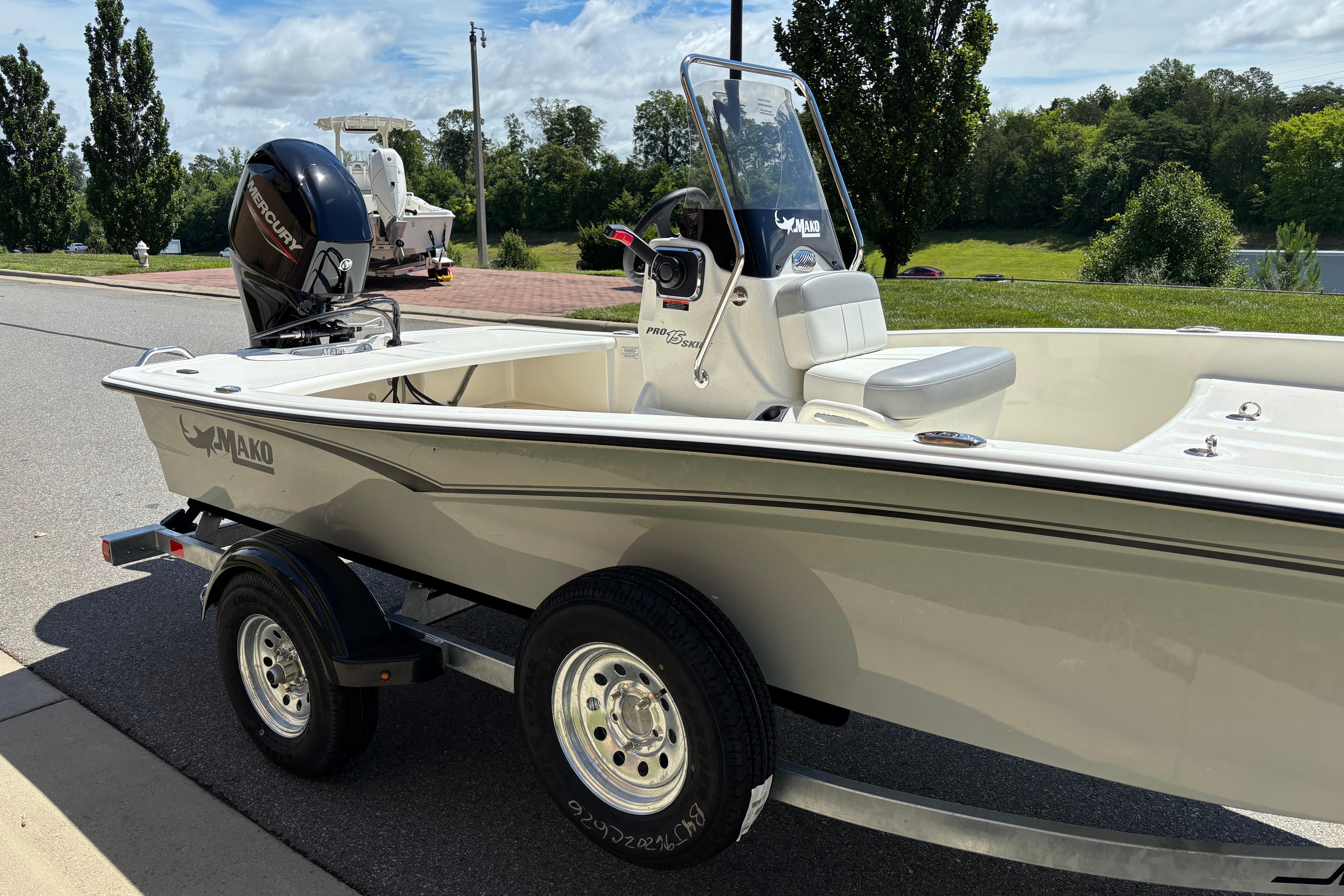 2026 Mako Pro Skiff 15 CC boat on trailer, parked outdoors on a sunny day.