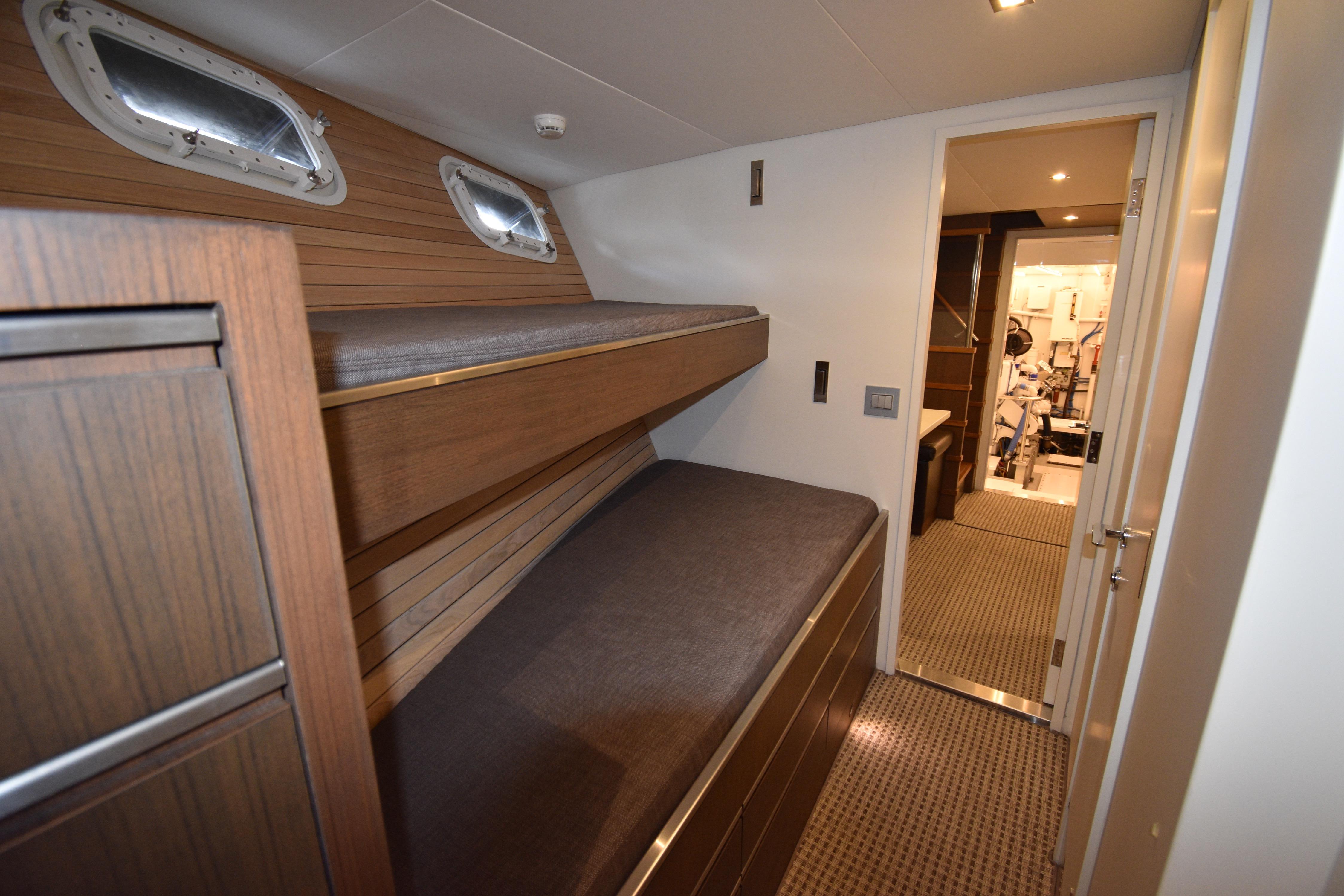 Interior of 1976 Burger Flush Deck Motor Yacht with bunk beds and wooden paneling.