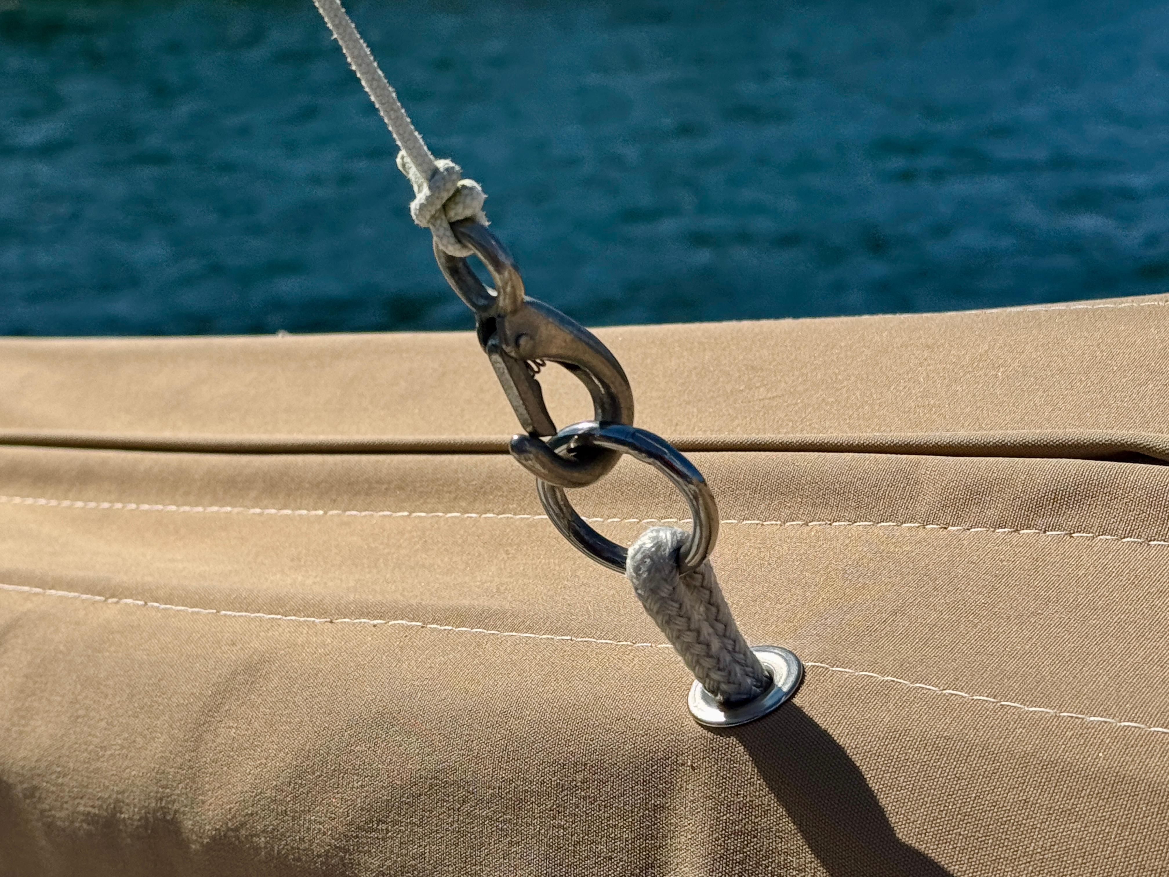 Close-up of a Nonsuch 30 Ultra sailboat rigging detail, 1989 model, with blue water background.