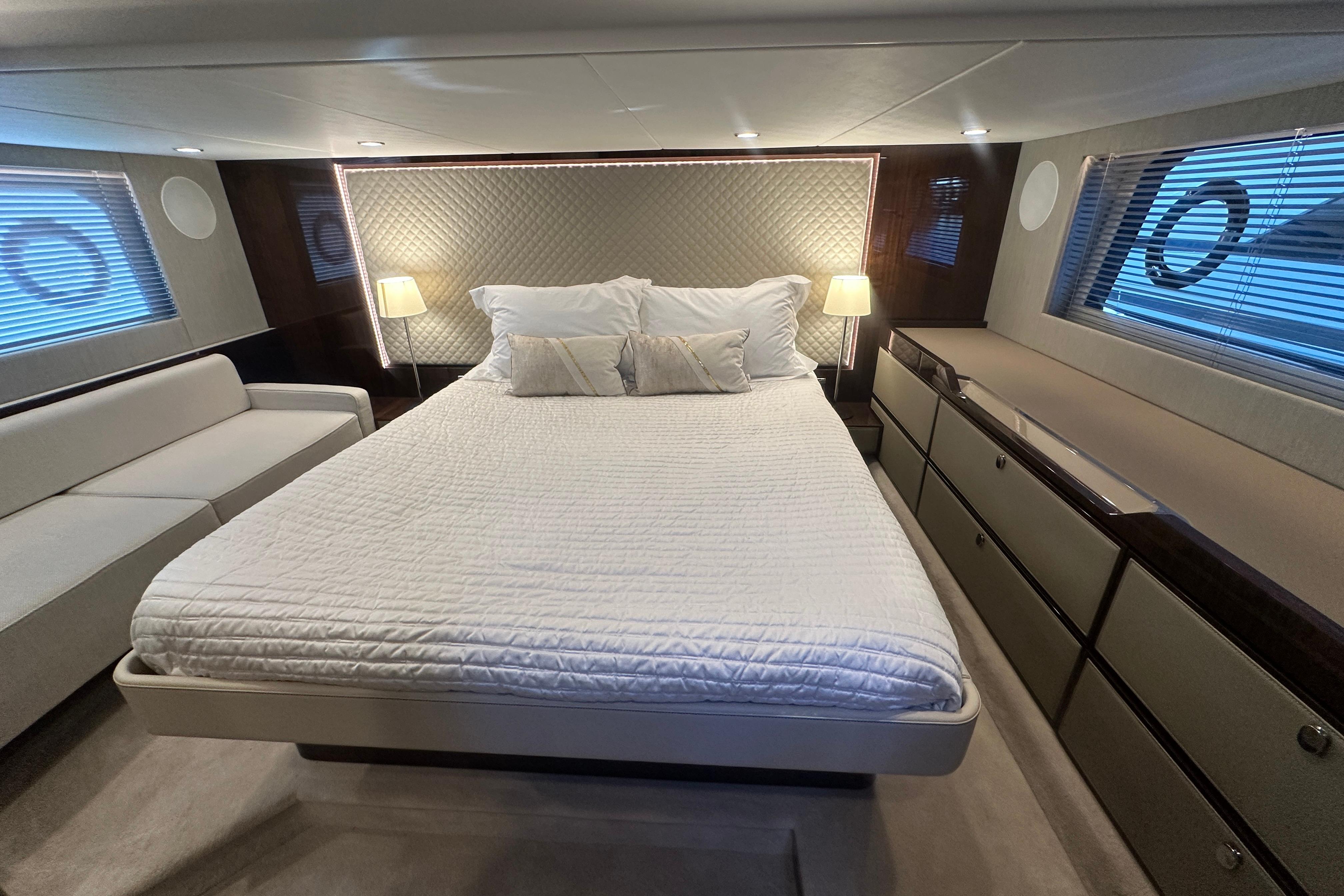 Luxurious bedroom interior of 2024 Fairline Squadron 50 yacht with elegant furnishings.