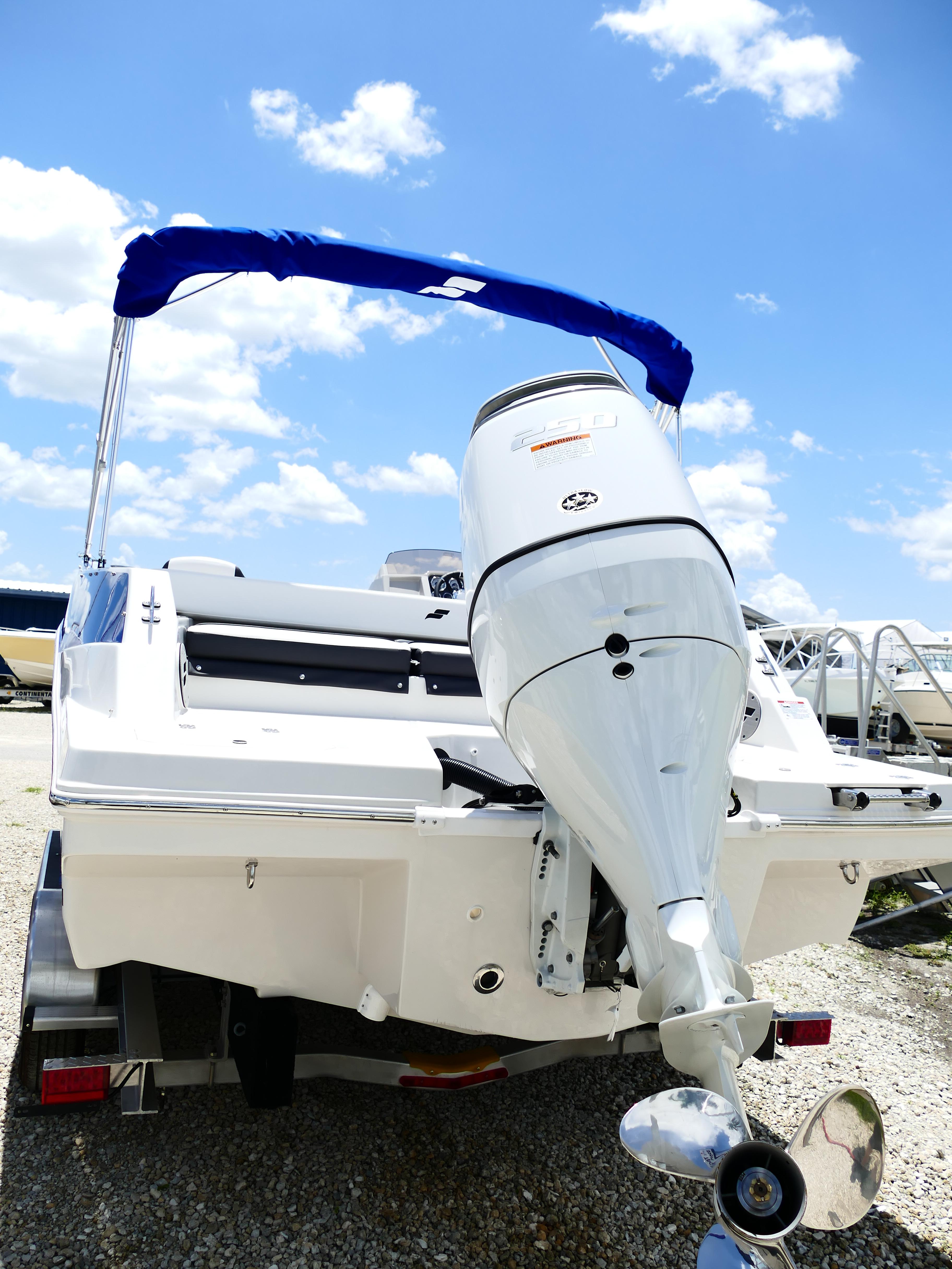 2026 Starcraft SVX 231 OB DH boat with outboard motor, under a clear blue sky.