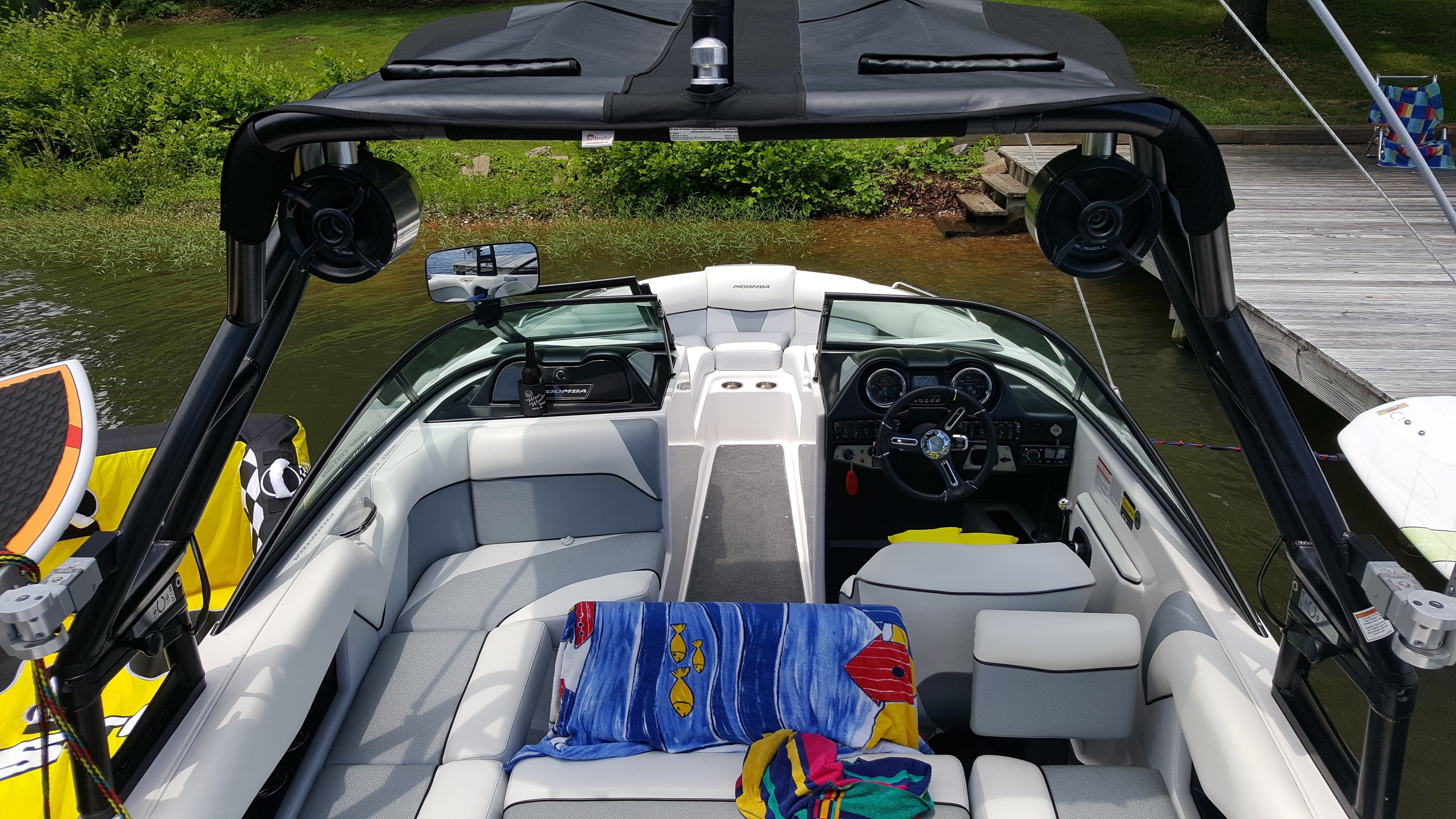 The image shows the interior of a 2016 Moomba Mondo boat with modern seating and controls.