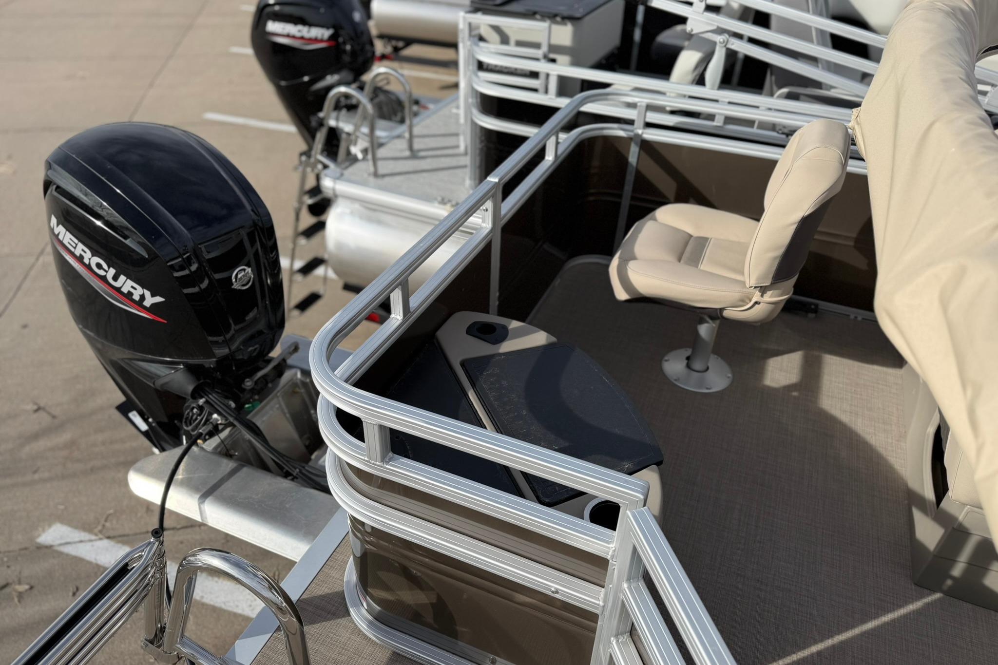 2025 Sun Tracker SportFish 20 DLX pontoon boat with Mercury outboard motor and seating area.