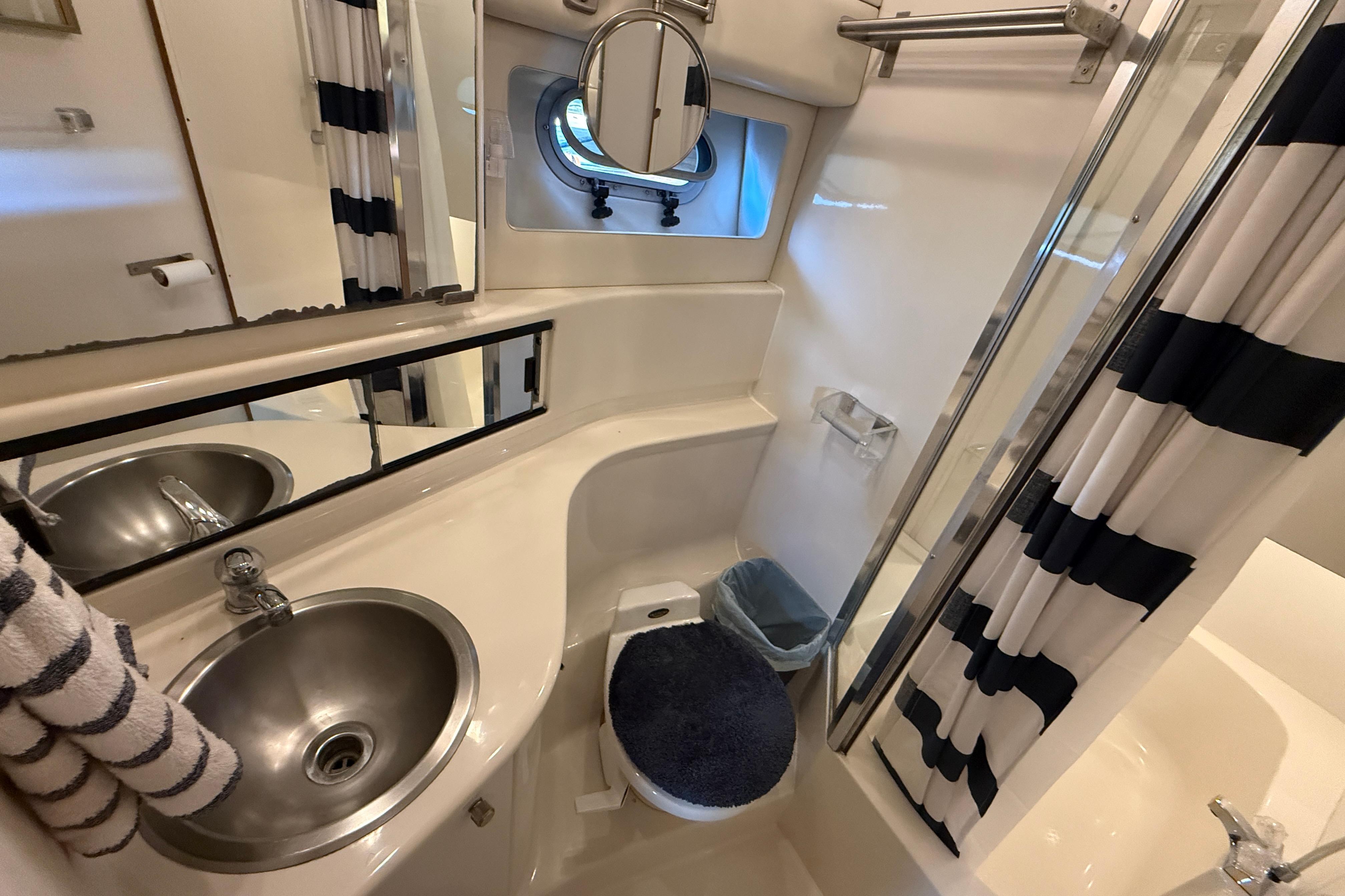 Bathroom interior of 1997 Bayliner 3988 Command Bridge Motoryacht with sink, toilet, and shower.