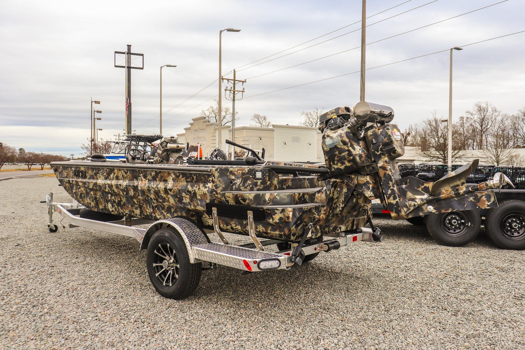 Camo-patterned 2026 Excel 1751 F4 boat on trailer, parked outdoors.
