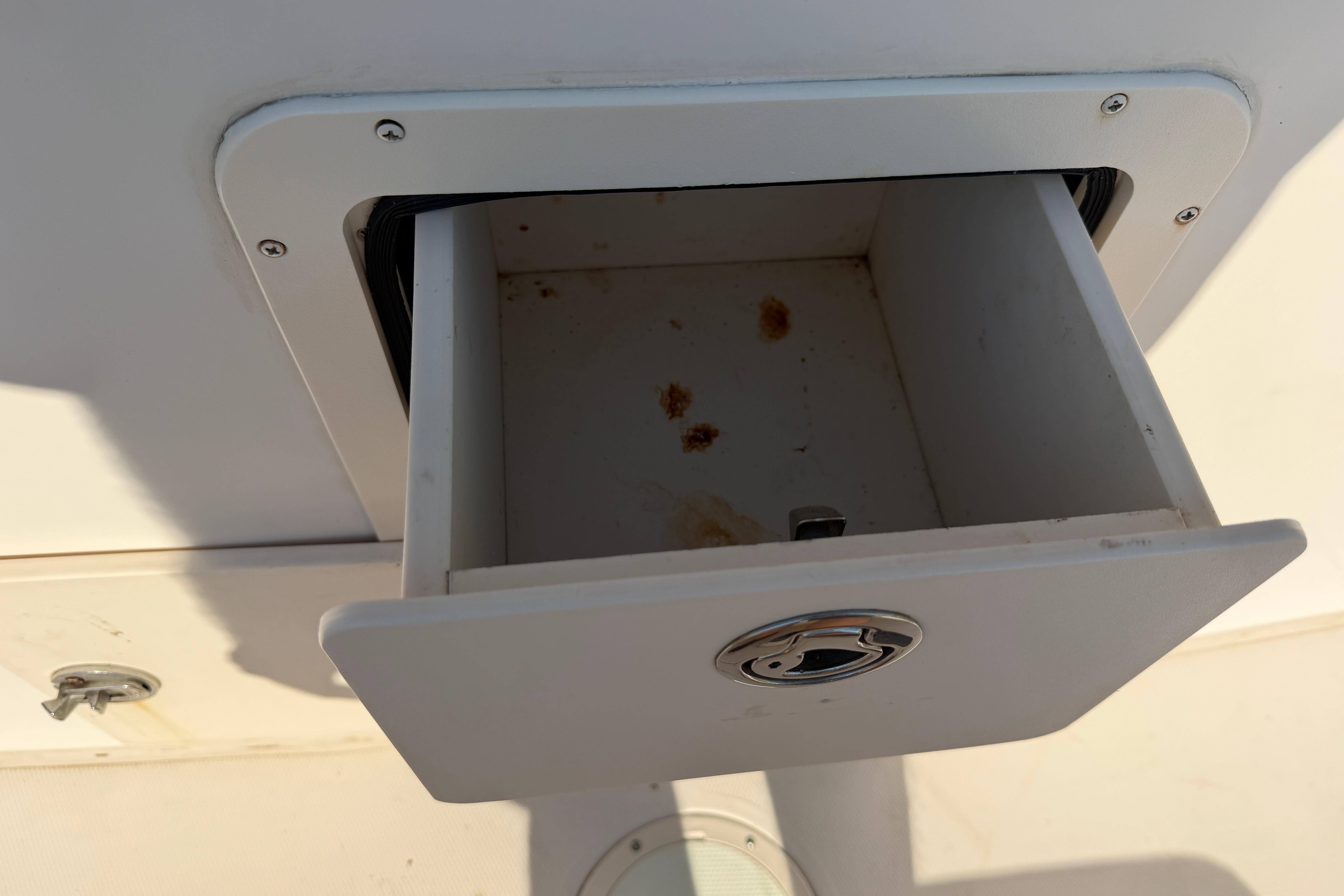 Open storage compartment on a 2010 Grady-White Canyon 336 boat.