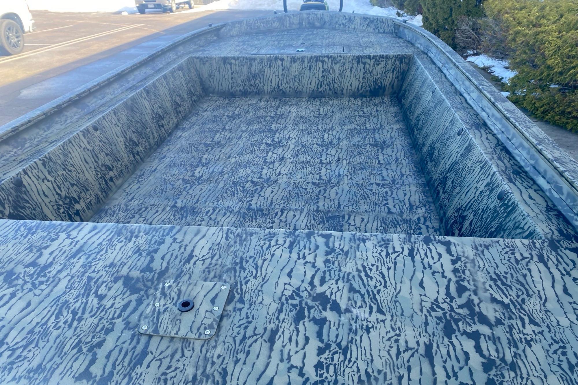 2026 Tracker Grizzly 1860 Utility boat with camouflage interior design.