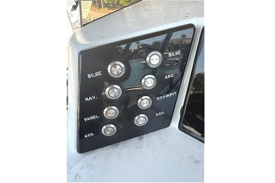 Control panel of 1996 Powerplay Powerboats 33 Sportfish with labeled buttons.