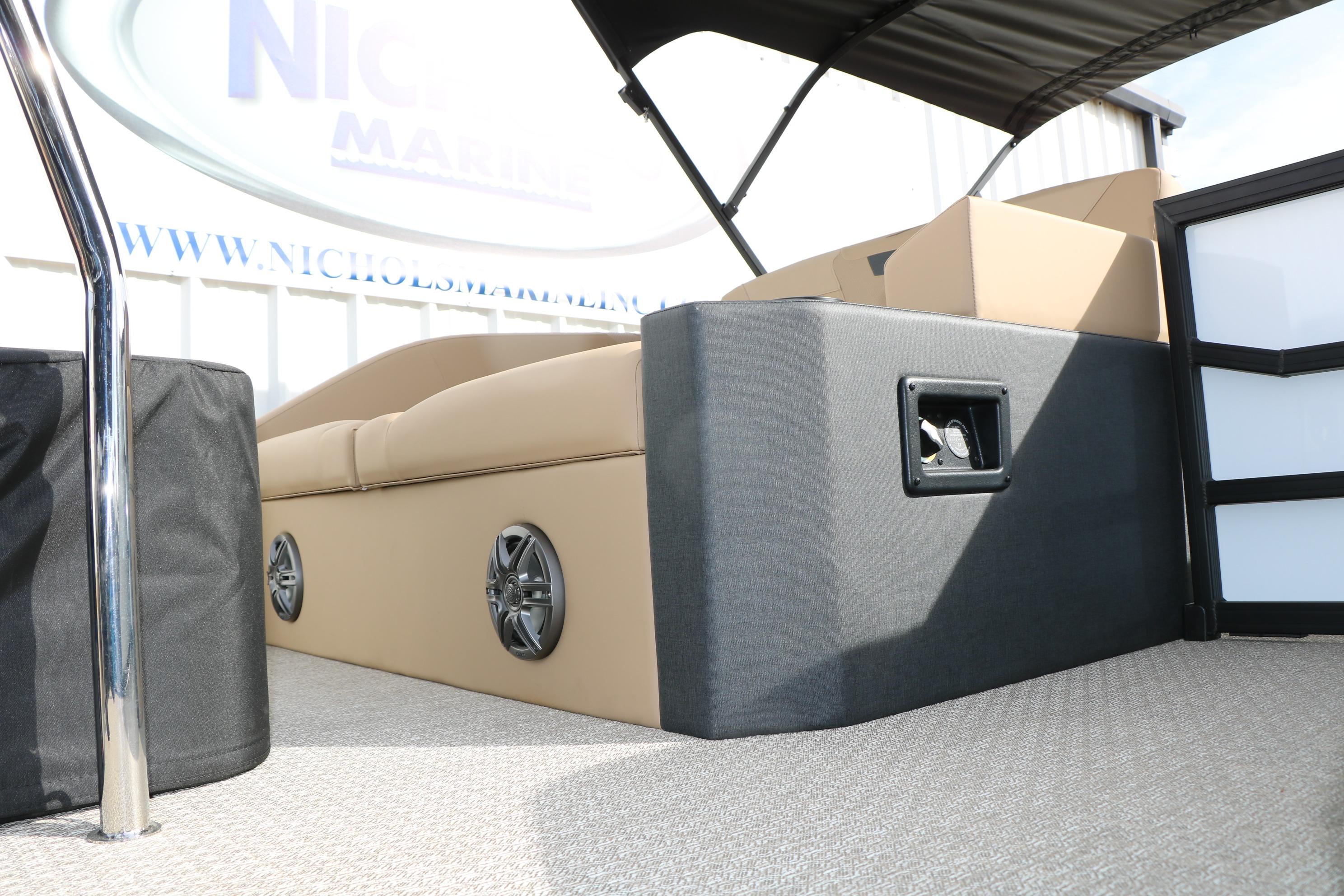 Interior of 2026 Evotti 523CS boat with beige seating and speaker system.