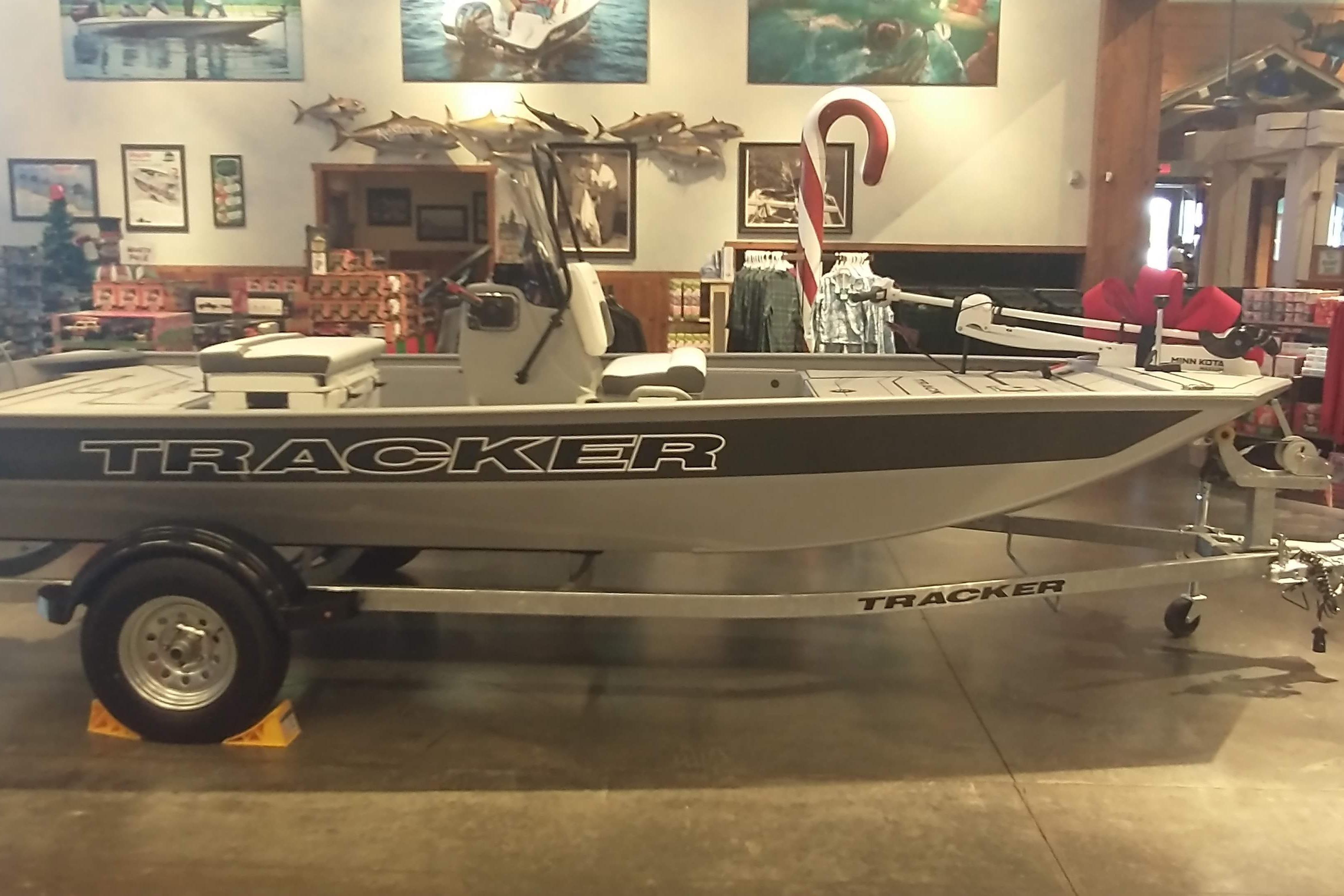 2026 Tracker Bass Tracker Classic CC boat displayed indoors with fishing gear.