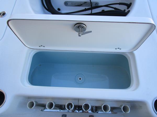 Sea Pro 230 Bay 2025 boat storage compartment with rod holders.