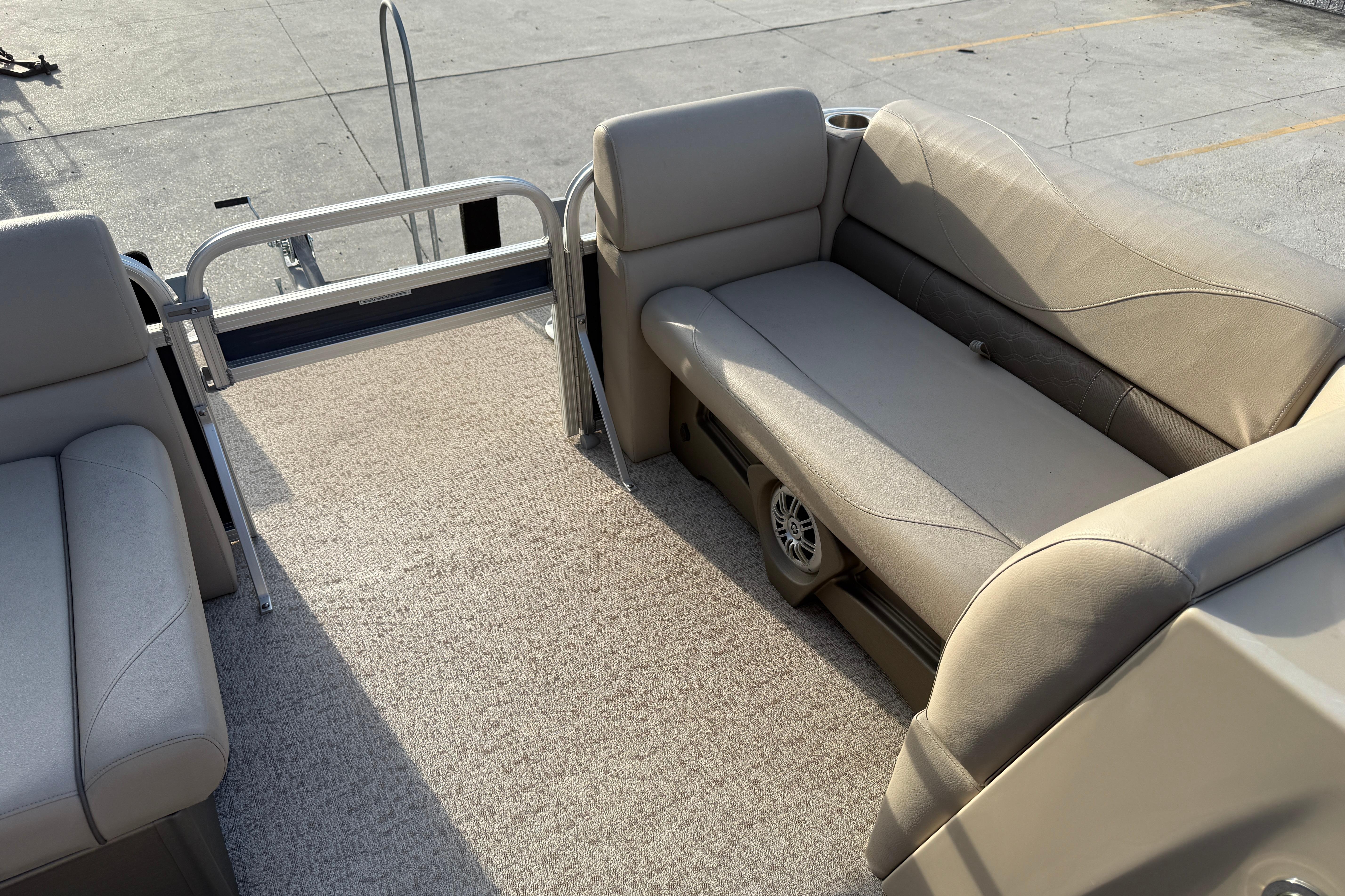 2019 Avalon Venture Fish N Cruise 20' boat interior with beige seating and carpeted floor.