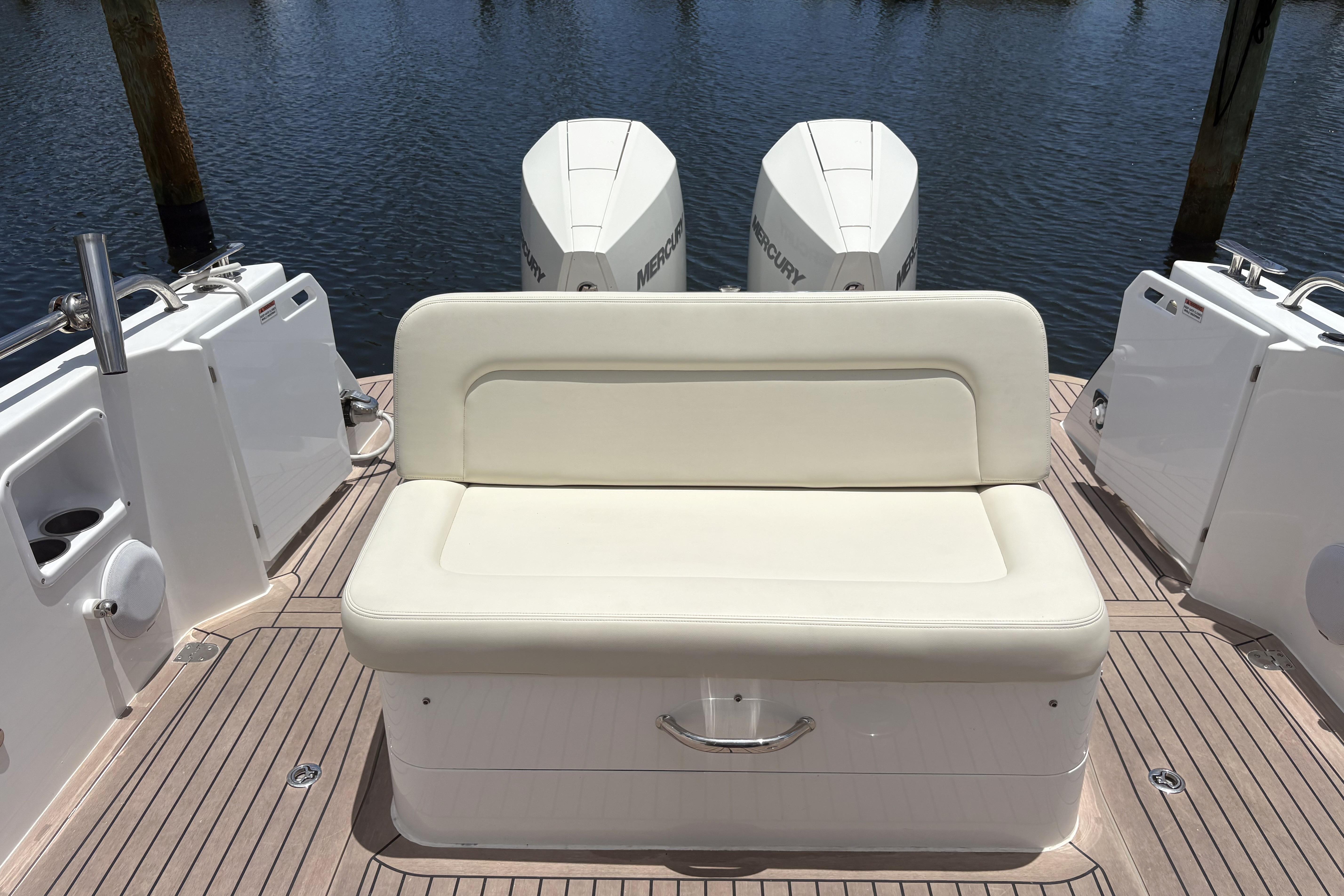 2024 MJM 35z boat with cushioned seating and twin Mercury outboard engines.