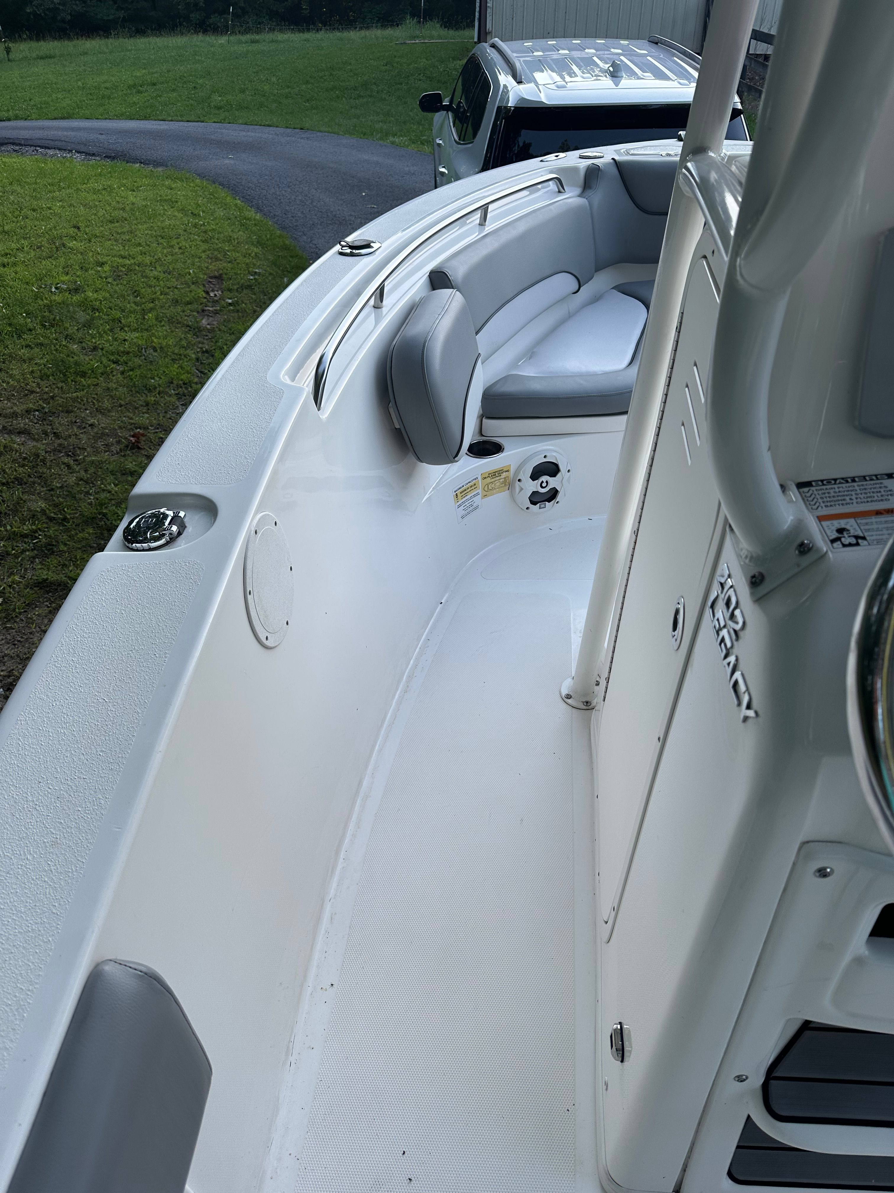 The image shows the deck of a 2022 NauticStar 2102 Legacy boat with gray upholstery.