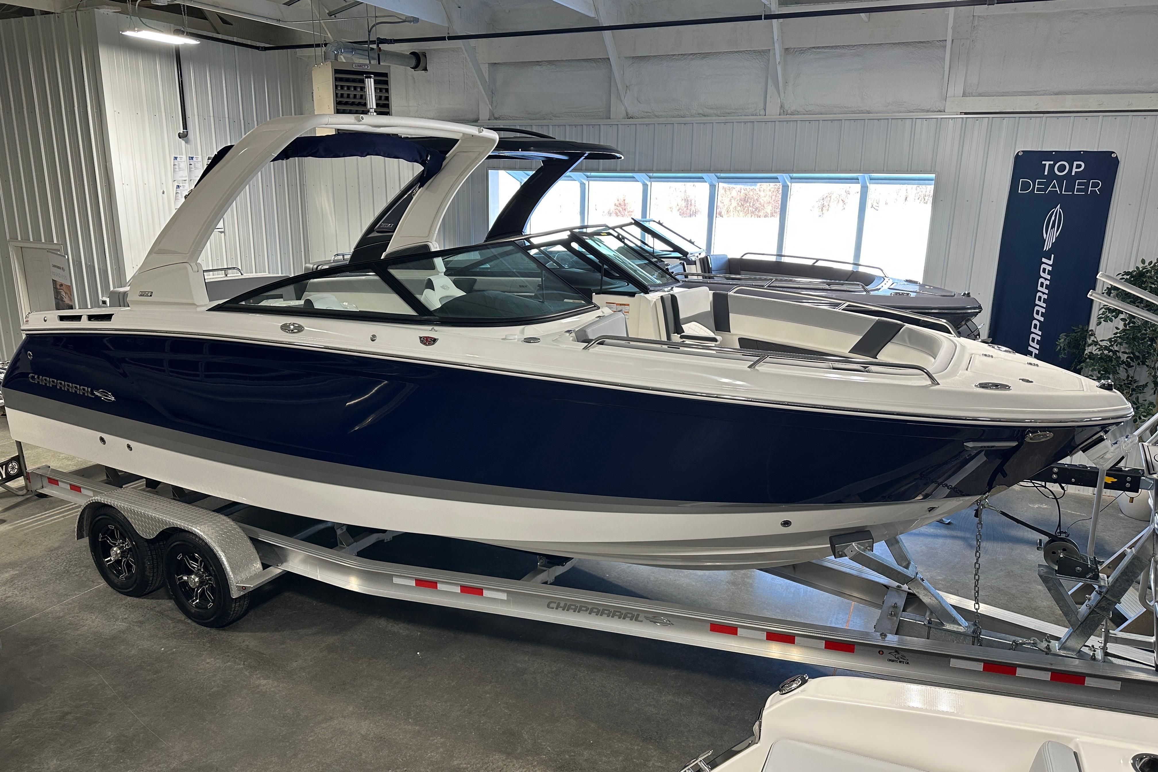 2026 Chaparral SSX 8 boat on trailer in showroom.