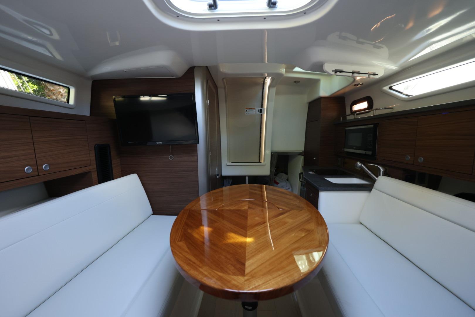 Interior of 2025 Boston Whaler 325 Conquest with wood accents and modern amenities.
