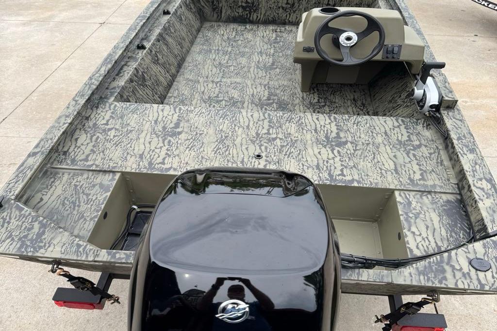 2026 Tracker Grizzly 1648 SC boat with camouflage interior and steering console.