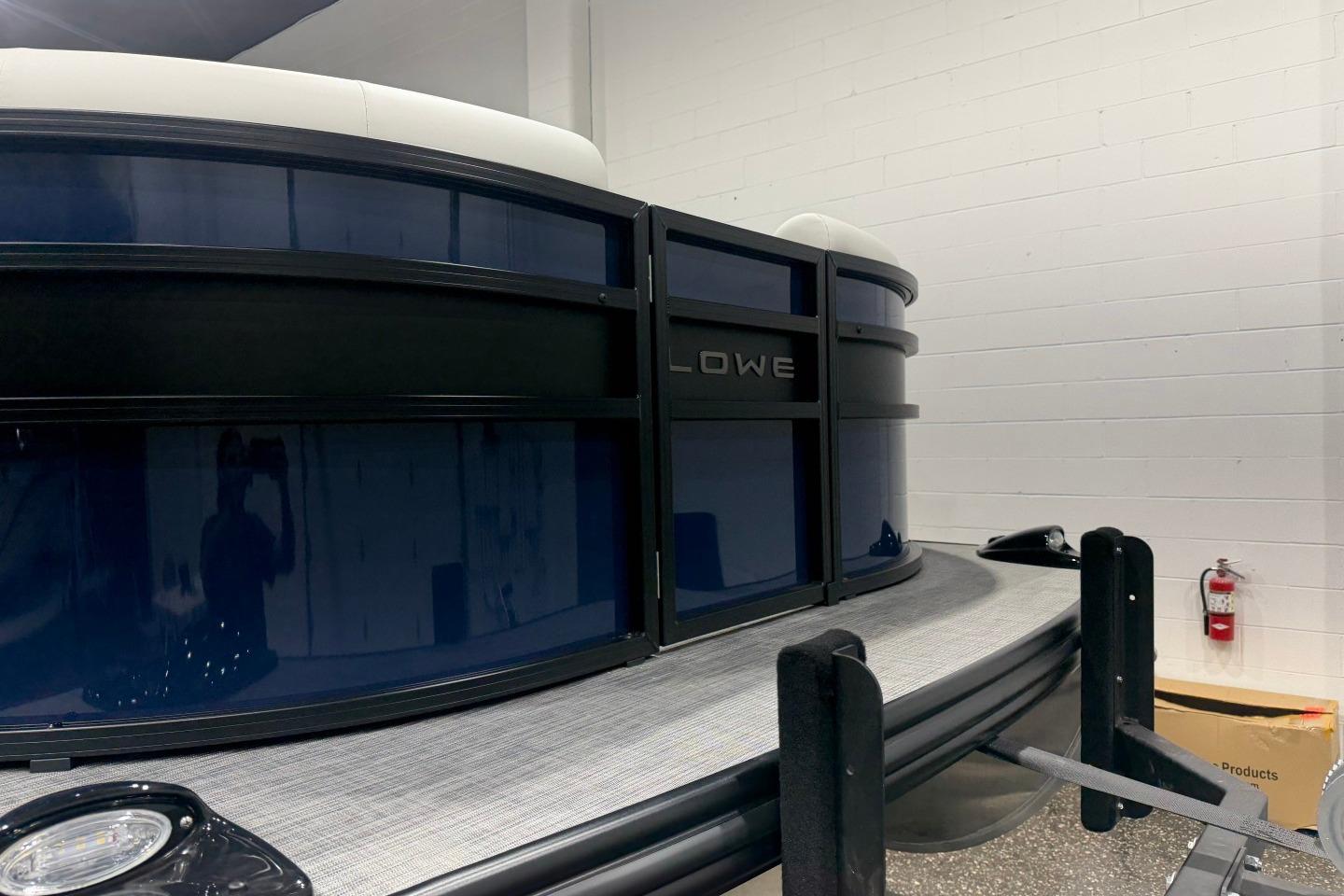 2026 Lowe SS 230 WT pontoon boat in showroom, featuring sleek design and modern finishes.