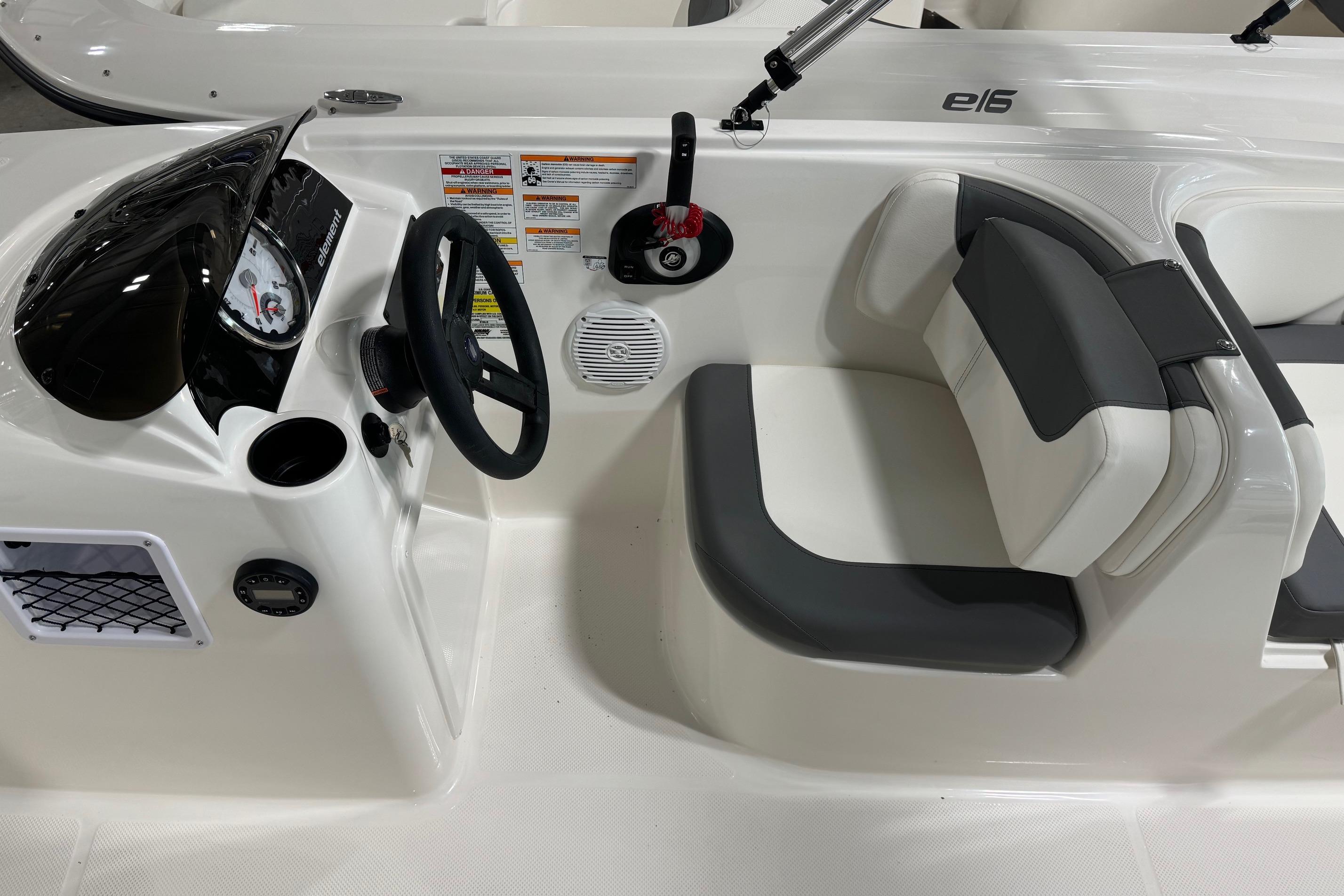 2025 Bayliner Element E18 boat interior with steering wheel and seating.