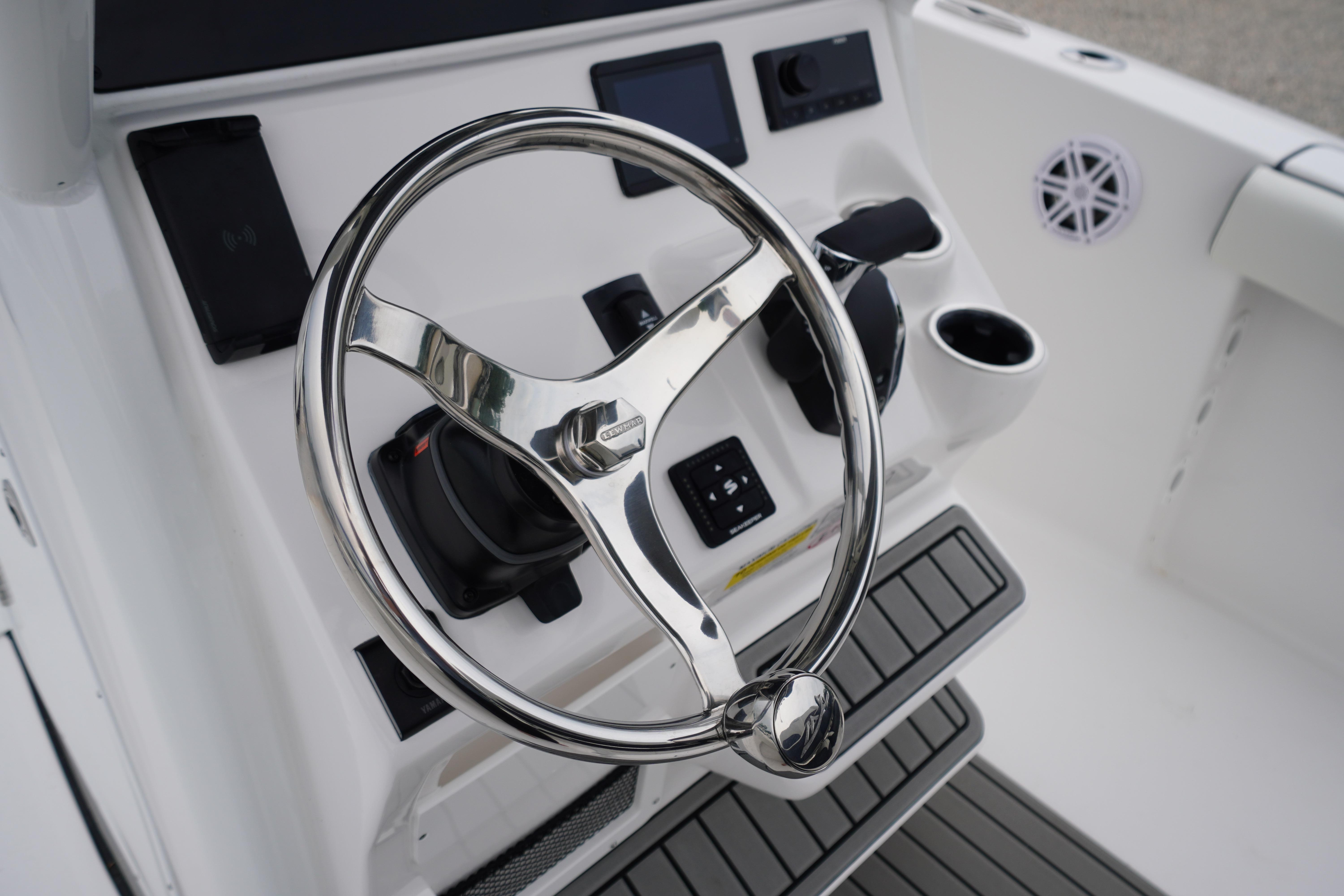 Steering wheel and controls of 2026 Tidewater 232 SS boat cockpit.