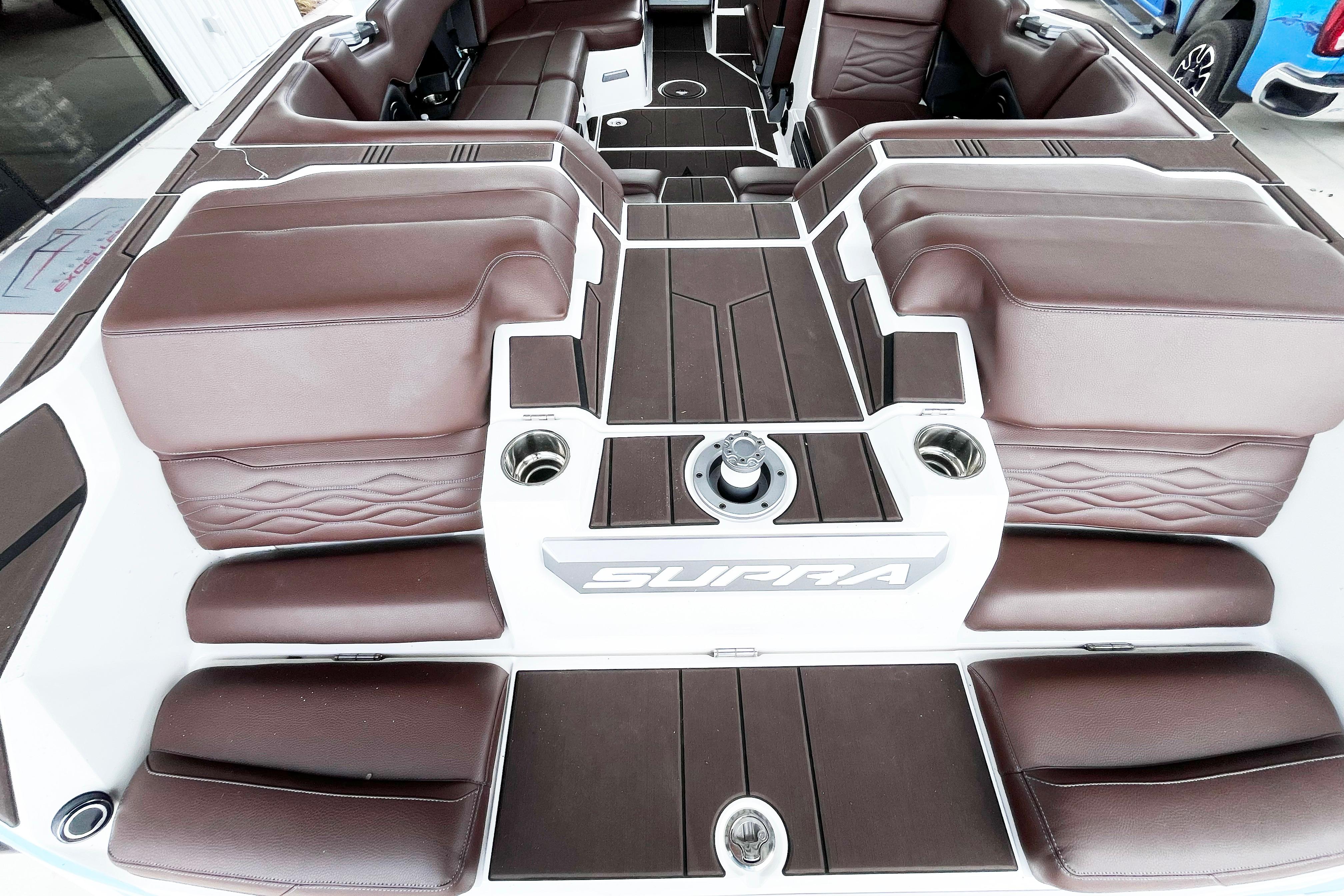 2025 Supra SA450 boat interior with brown leather seating and modern design.