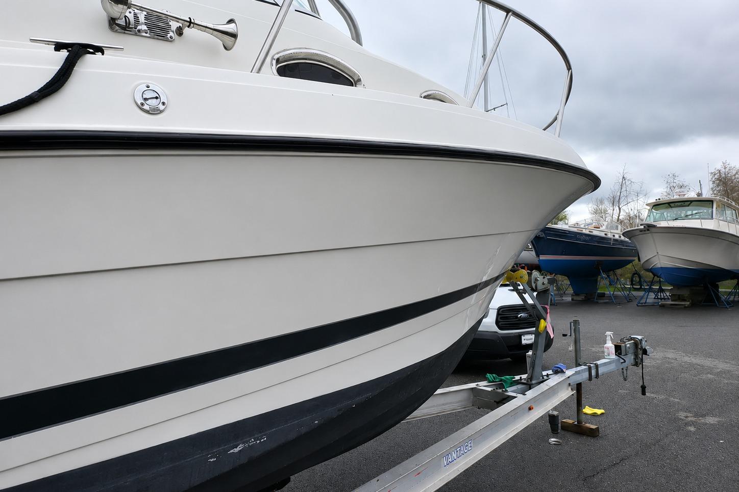 2003 Hydra-Sports Vector 2800 WA boat on trailer, parked with other boats.