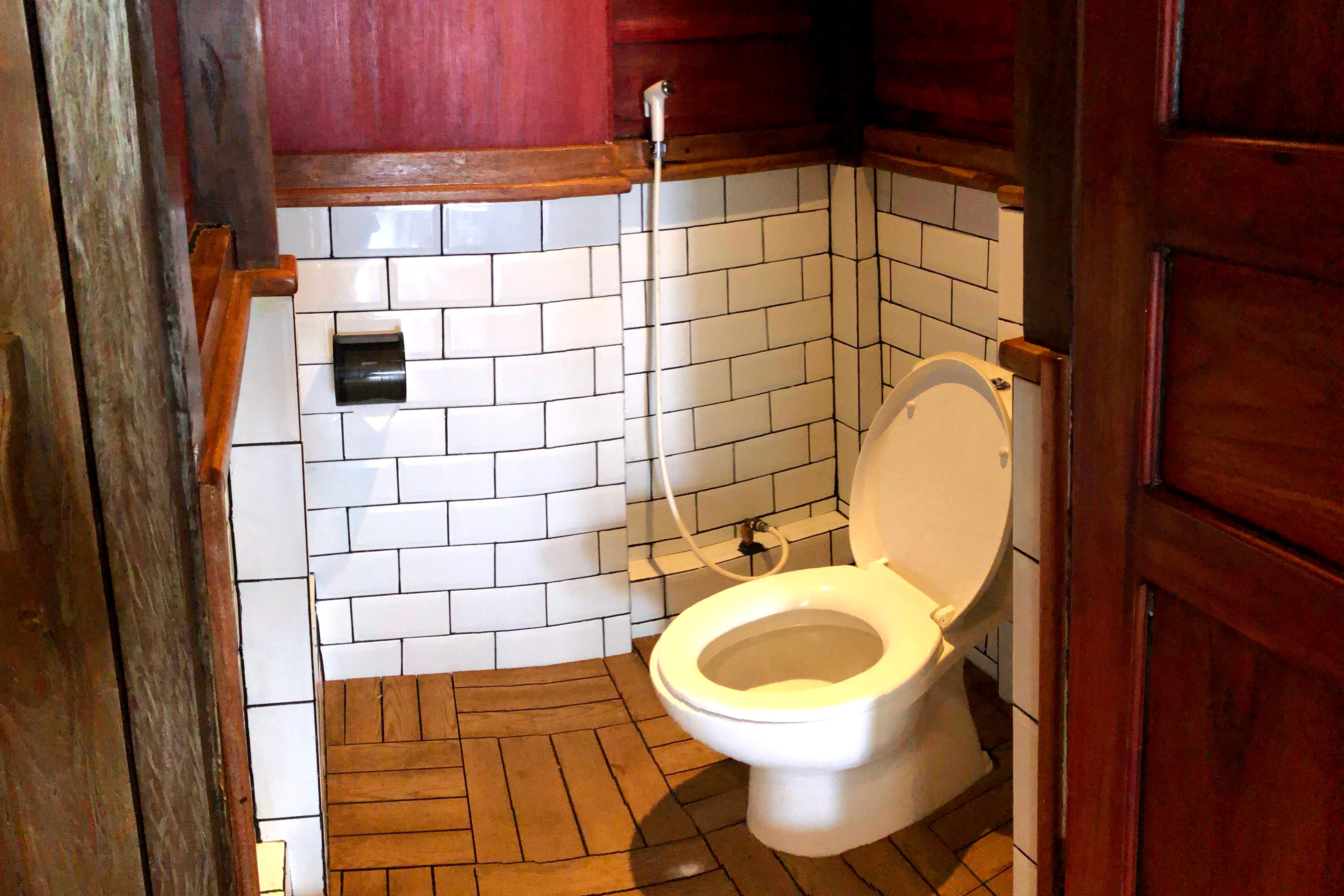 Wooden bathroom with white tiles on Phinisi Kartini, 2017 model.