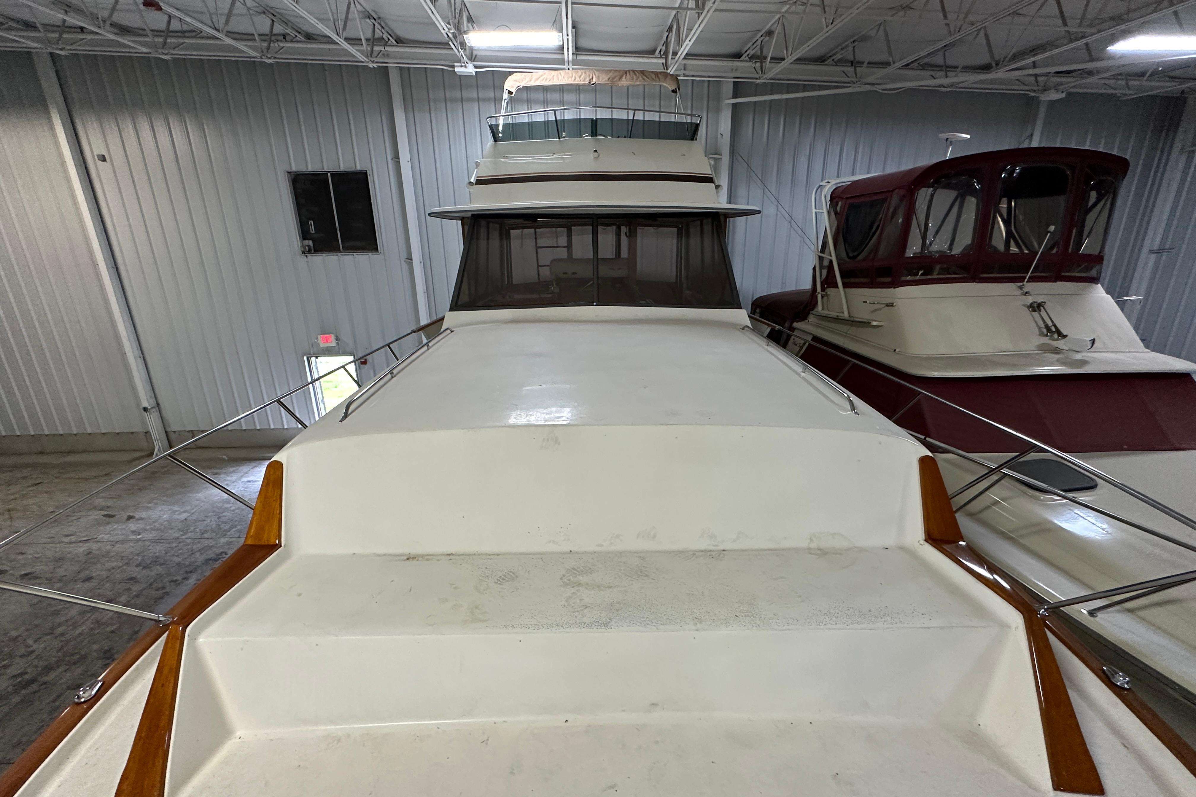 1982 Egg Harbor 42 Flybridge Motoryacht in indoor storage, showcasing spacious deck and sleek design.