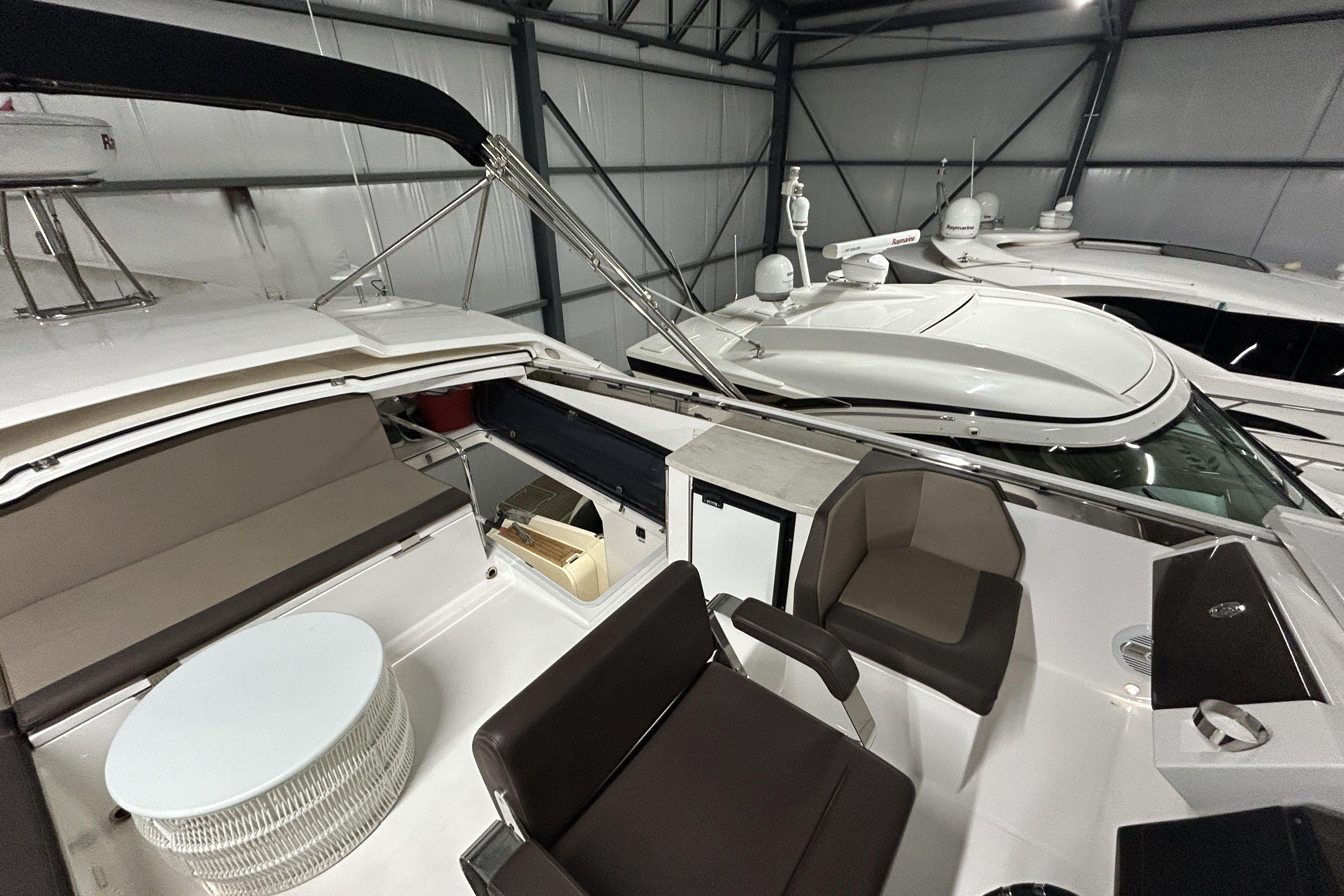 2018 Galeon 560 Sky yacht interior with seating and table in a storage facility.