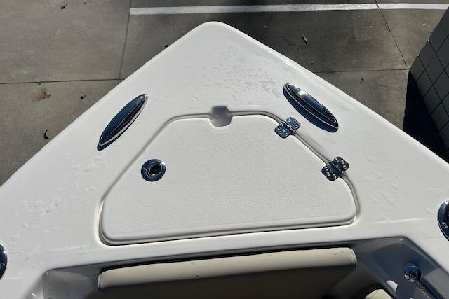 Bow of 2026 Key West 239 FS boat with storage hatch and cleats.