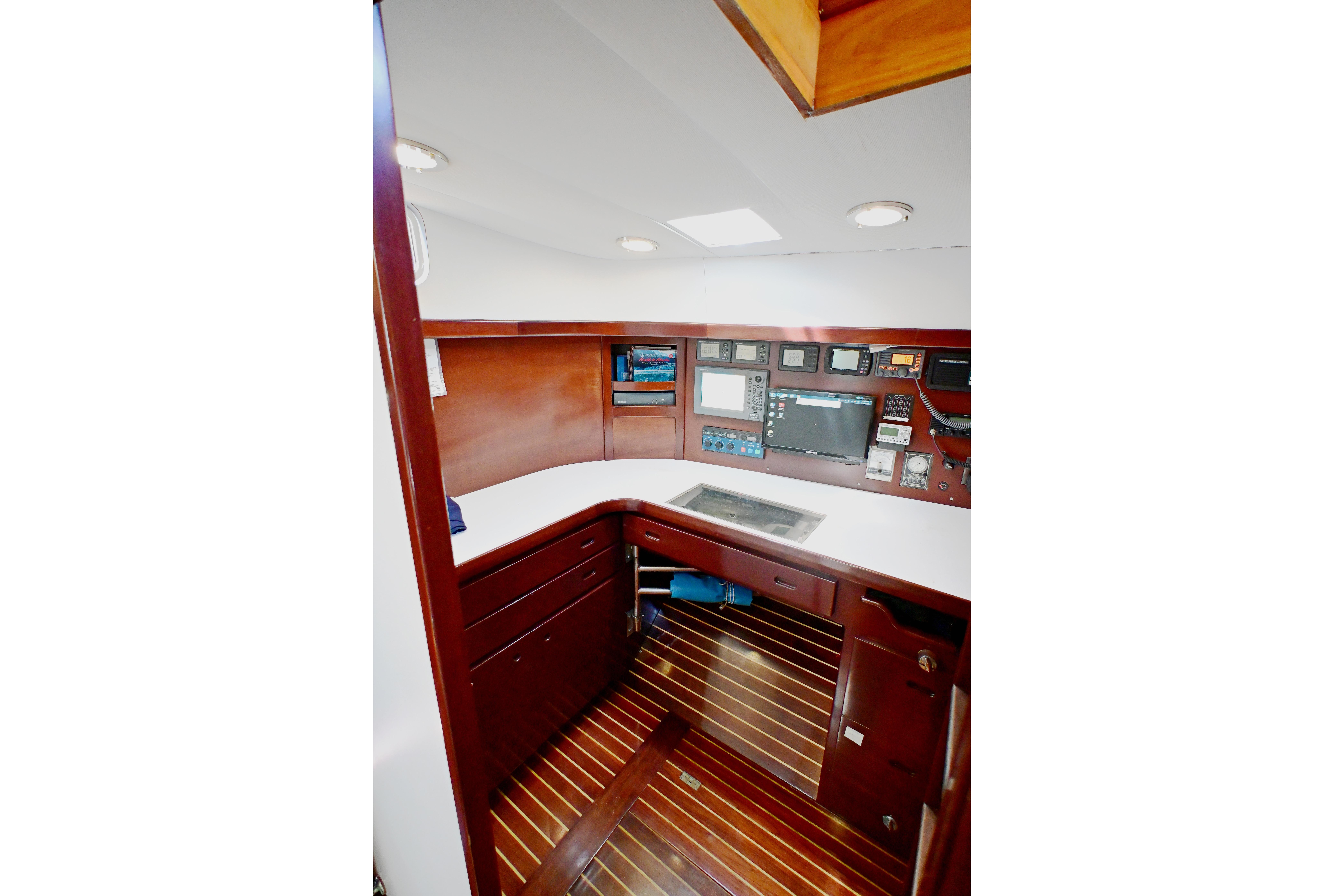 Navigation station of 1968 Abeking & Rasmussen Tripp 74 yacht with wood paneling and instruments.