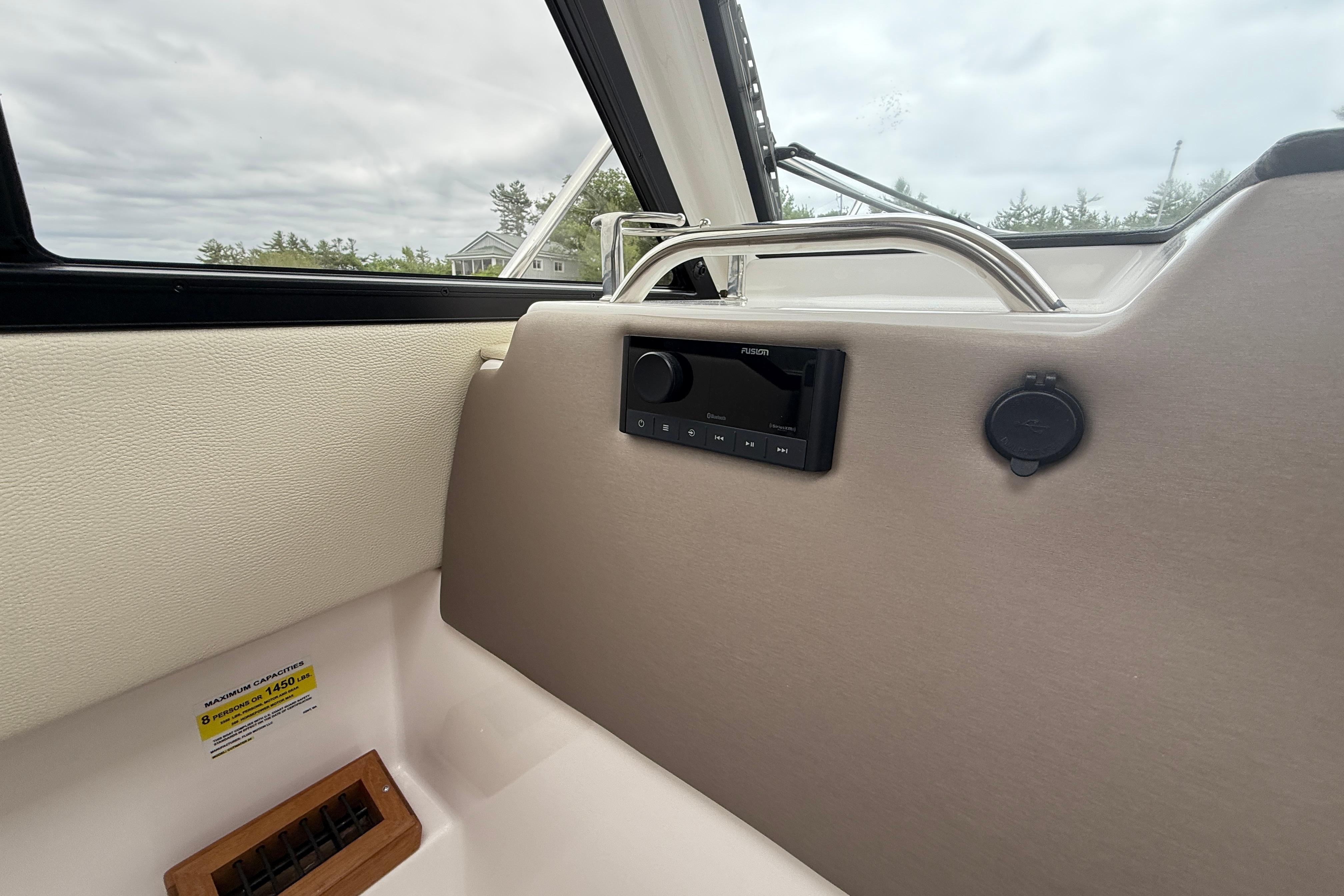 Interior of 2023 Cutwater C-248 Coupe boat with audio system and capacity label.