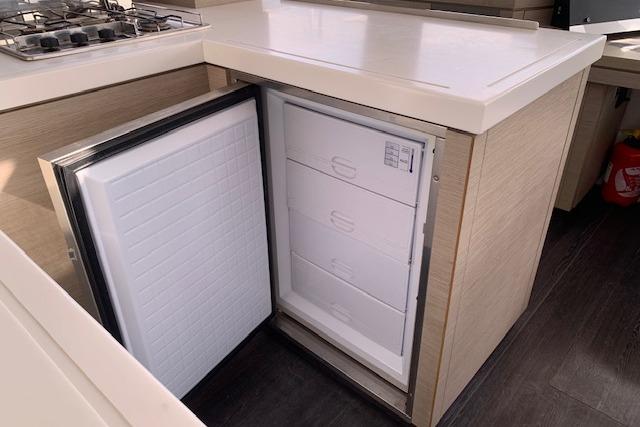 Modern kitchen on 2020 Fountaine Pajot Astrea 42 yacht with open refrigerator.