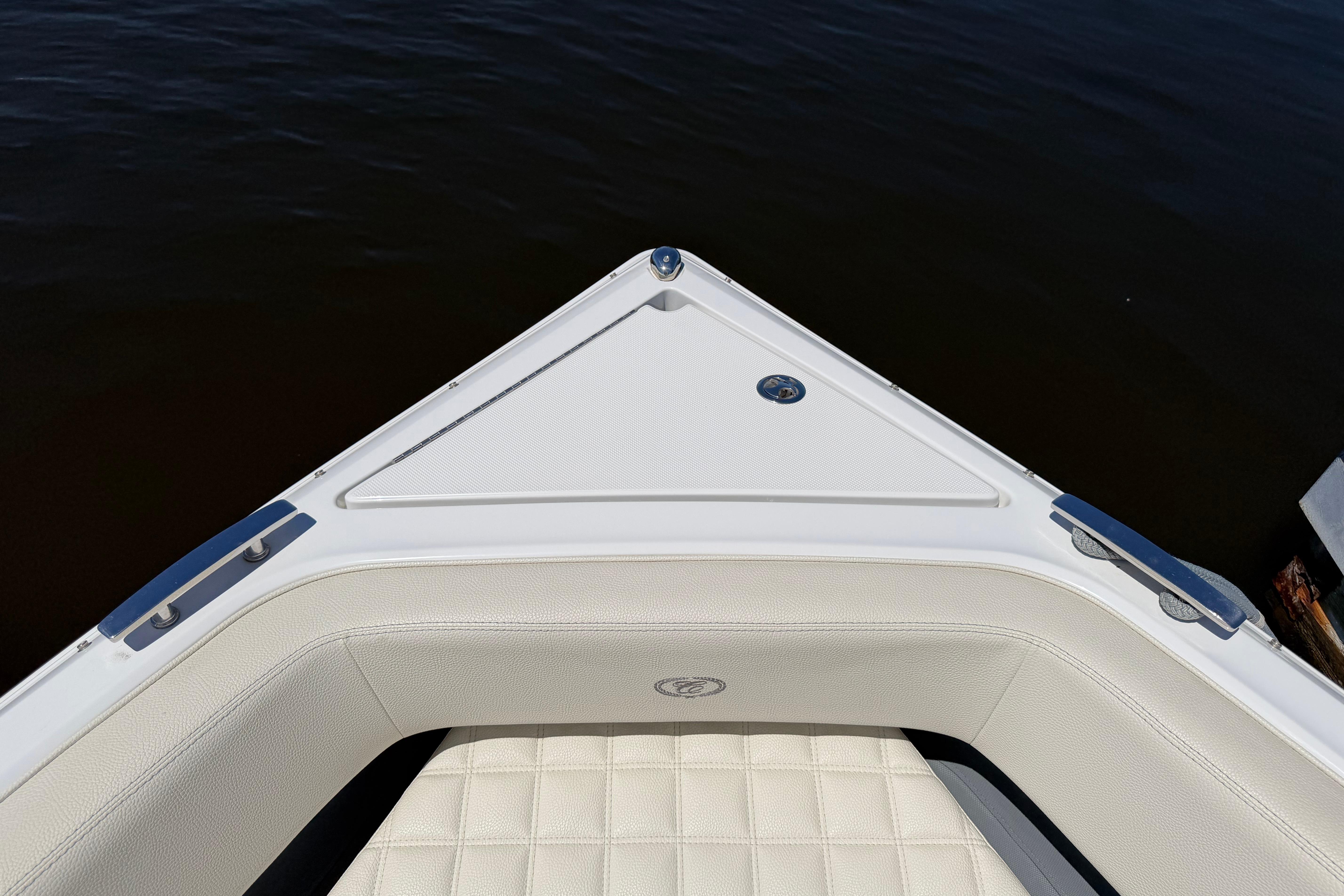 Bow of 2020 Cobalt R3 boat with white seating and dark water background.