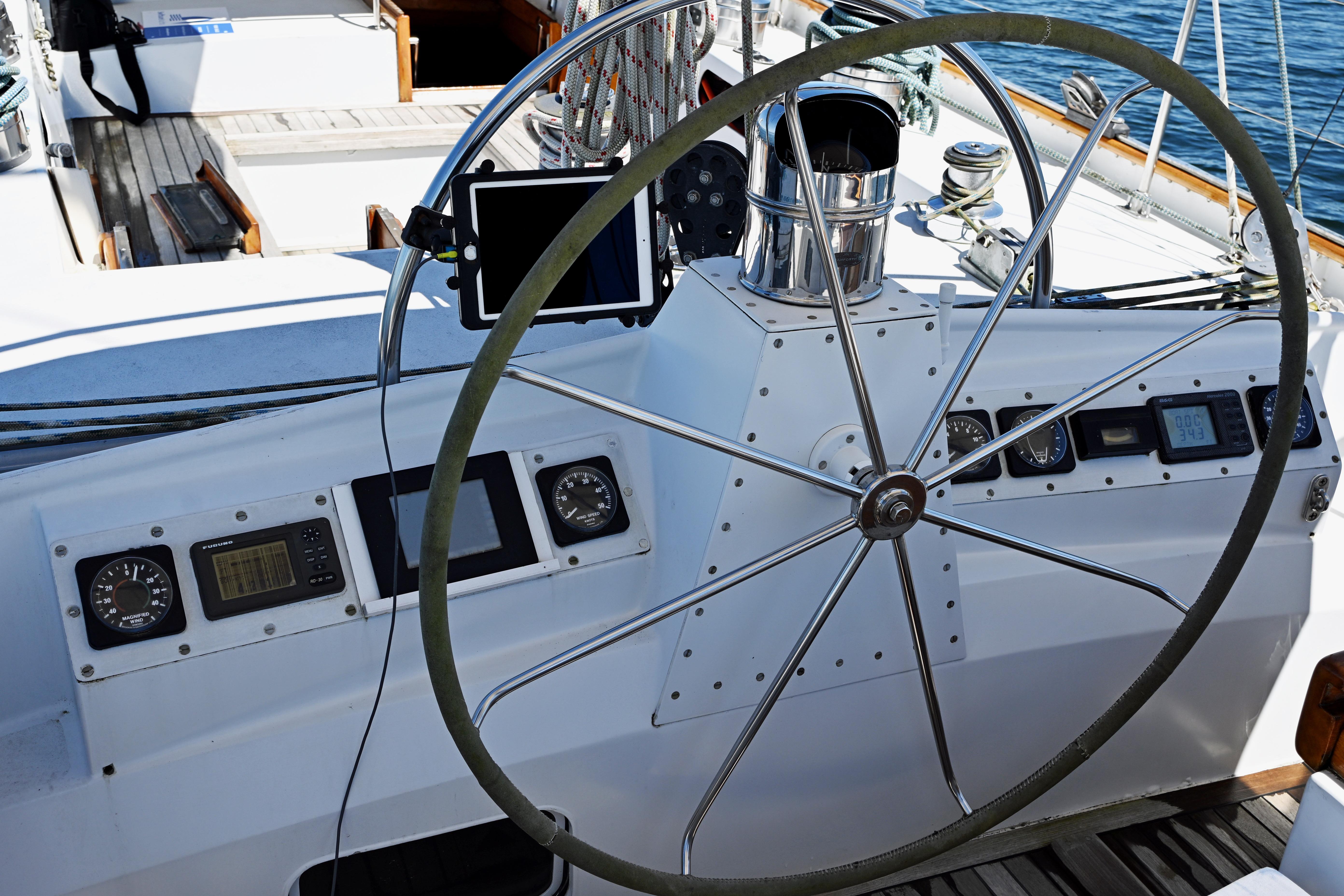 Steering wheel of a 1968 Abeking & Rasmussen Tripp 74 yacht with navigation instruments.