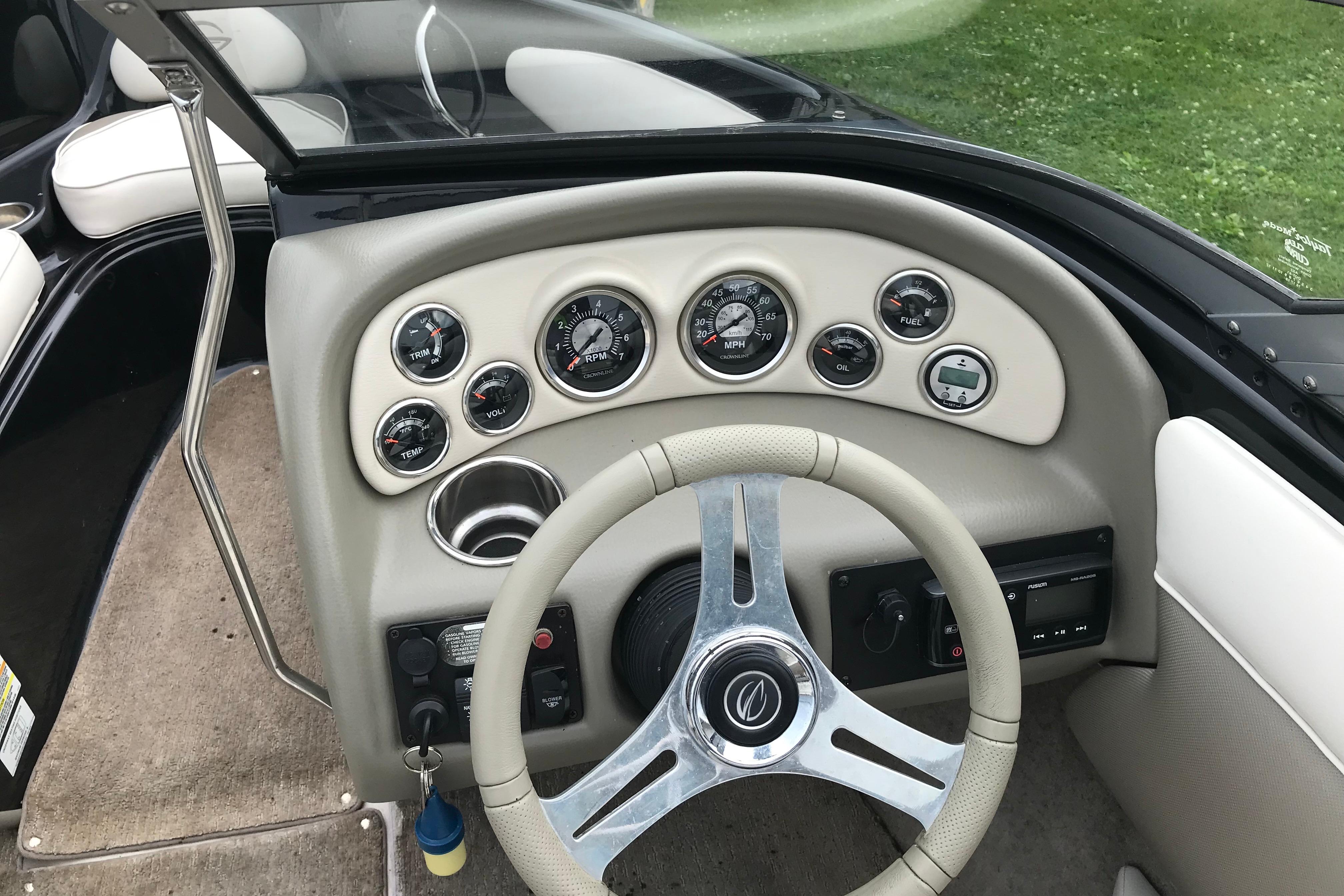 2015 Crownline 18 SS boat dashboard with gauges and steering wheel.