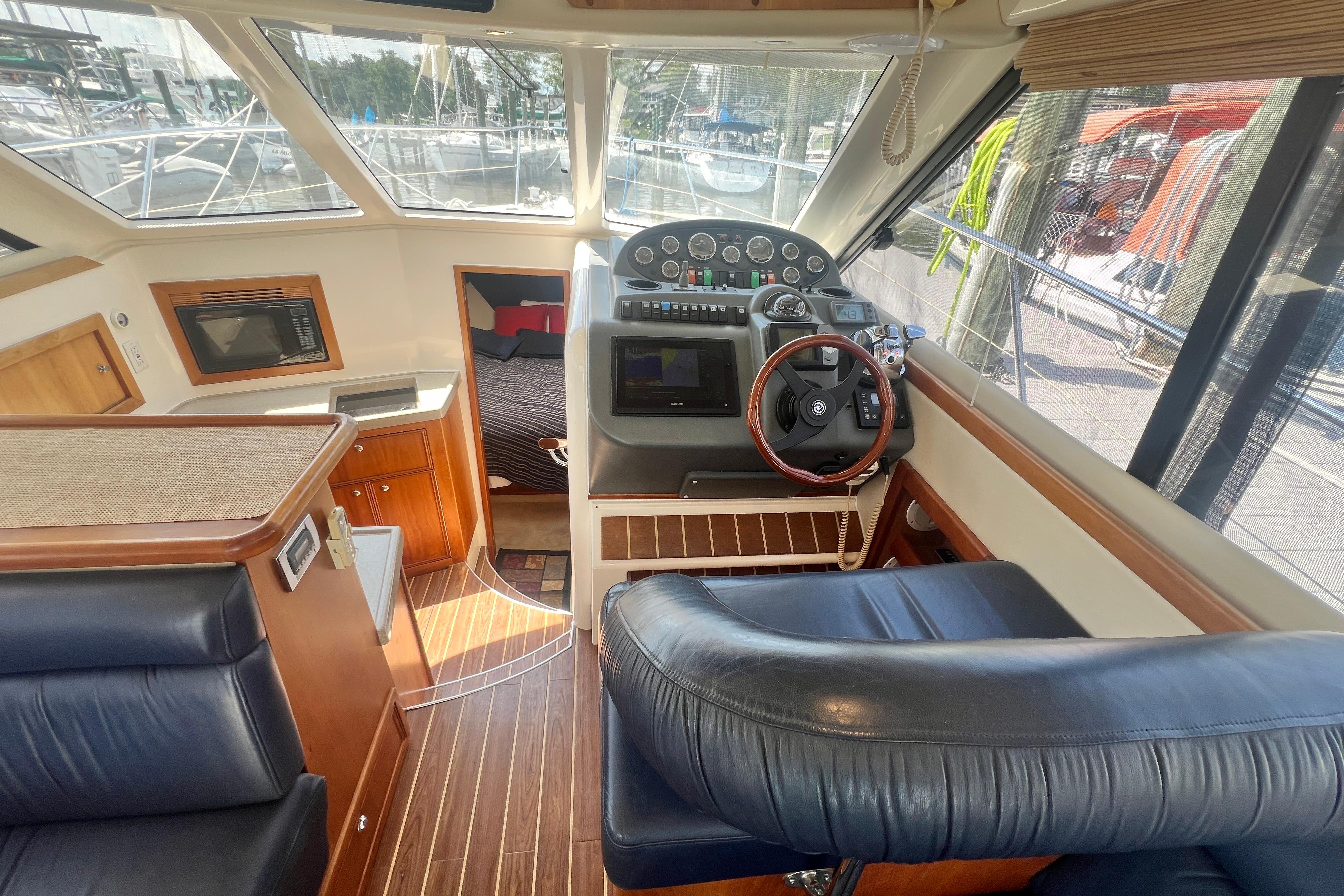 Interior view of 2007 Riviera 33 Flybridge yacht with helm and cabin area.