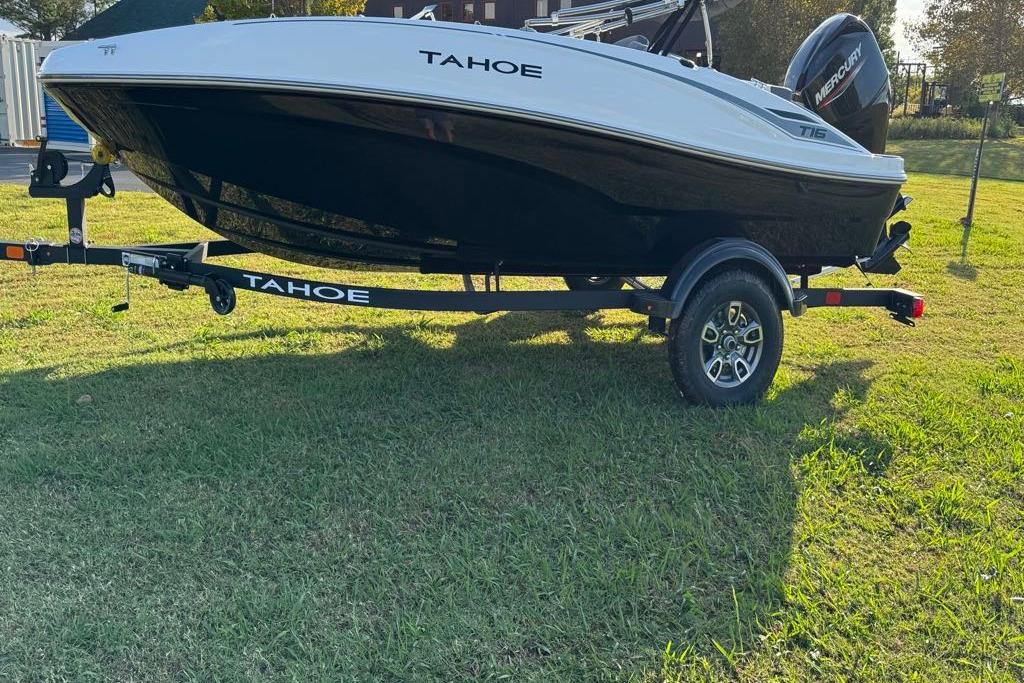 2026 Tahoe T16 boat on trailer, parked on grassy field.