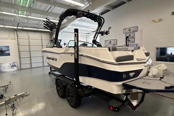 2025 MasterCraft XT22 boat in showroom, featuring sleek design and modern amenities.