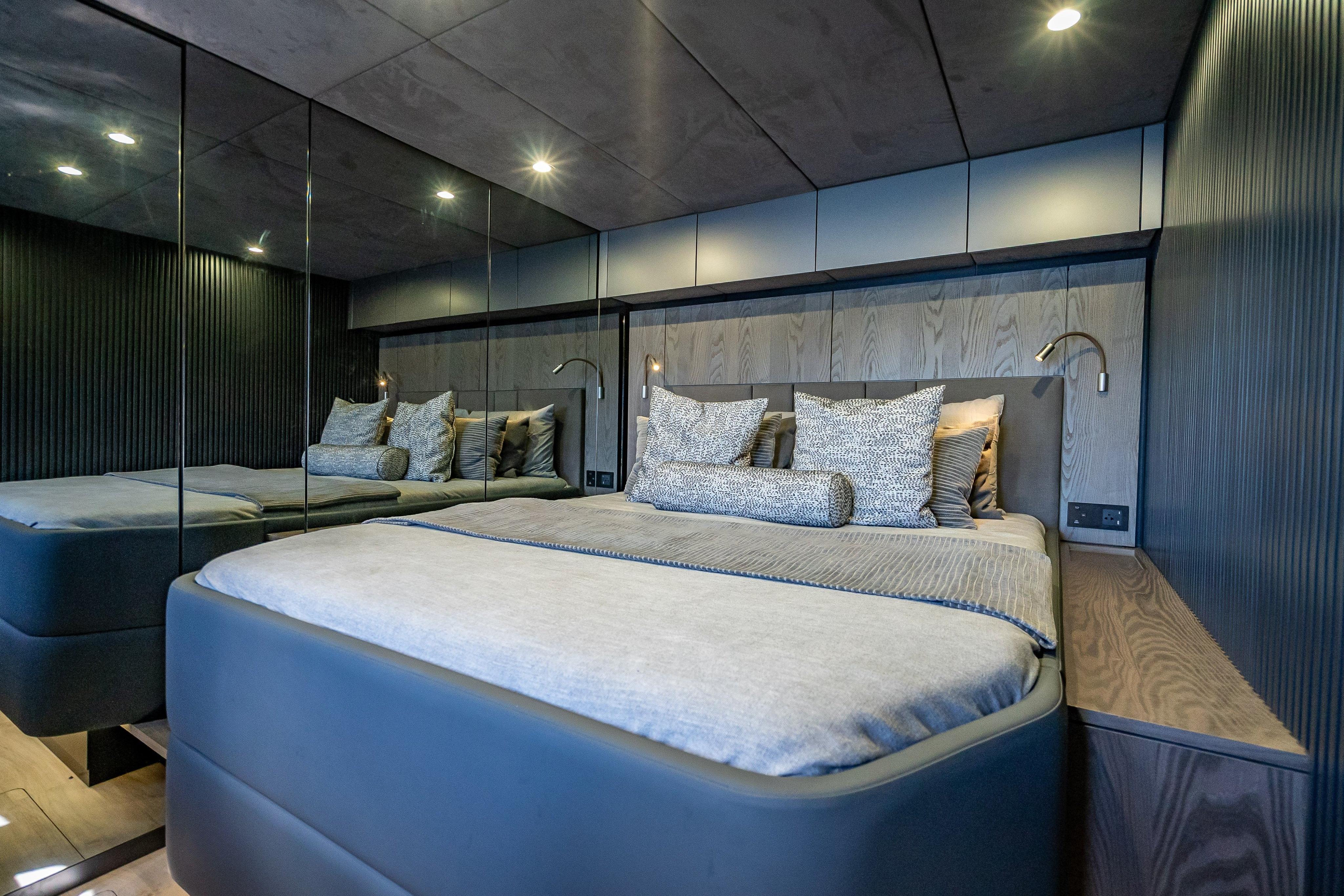 Luxurious bedroom interior on 2026 Sunreef 60 Power yacht, featuring modern design and elegant bedding.