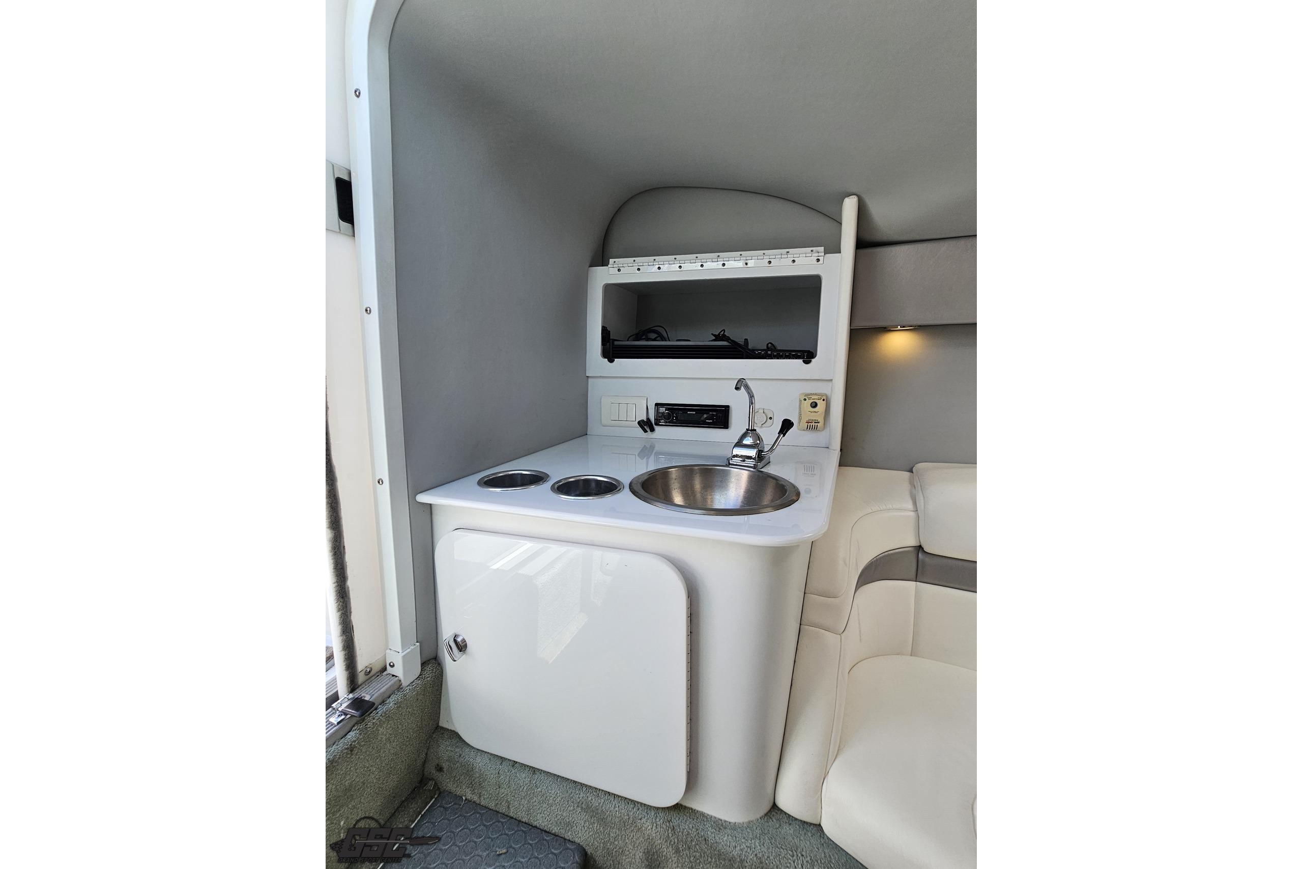 2005 Formula 271 FASTech boat interior with compact kitchenette and sink.