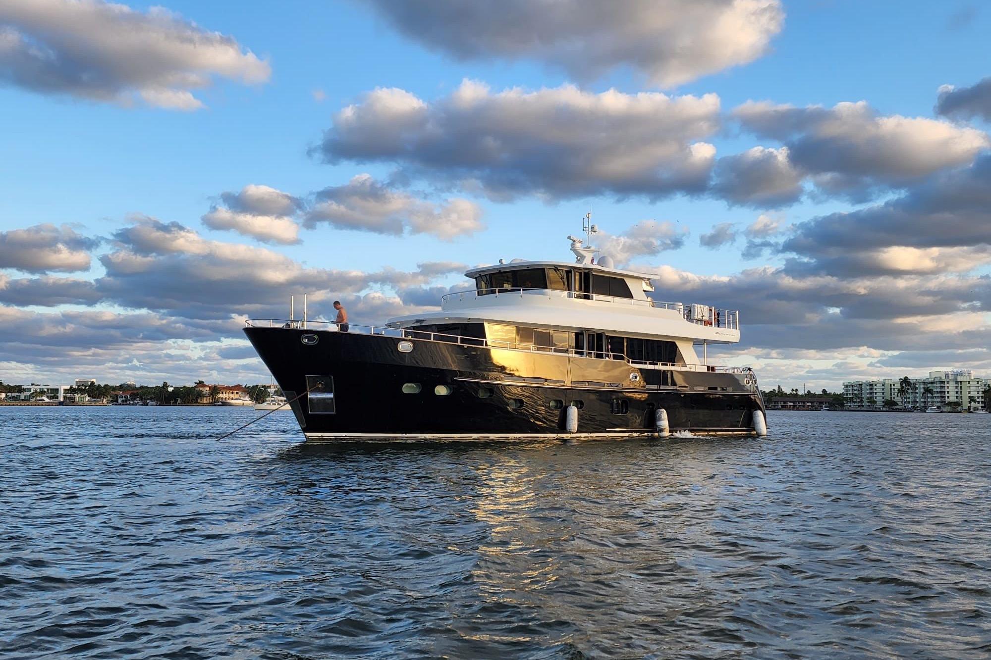2014 Fifth Ocean Yachts 24m Displacement Explorer Yacht on calm water under cloudy sky.