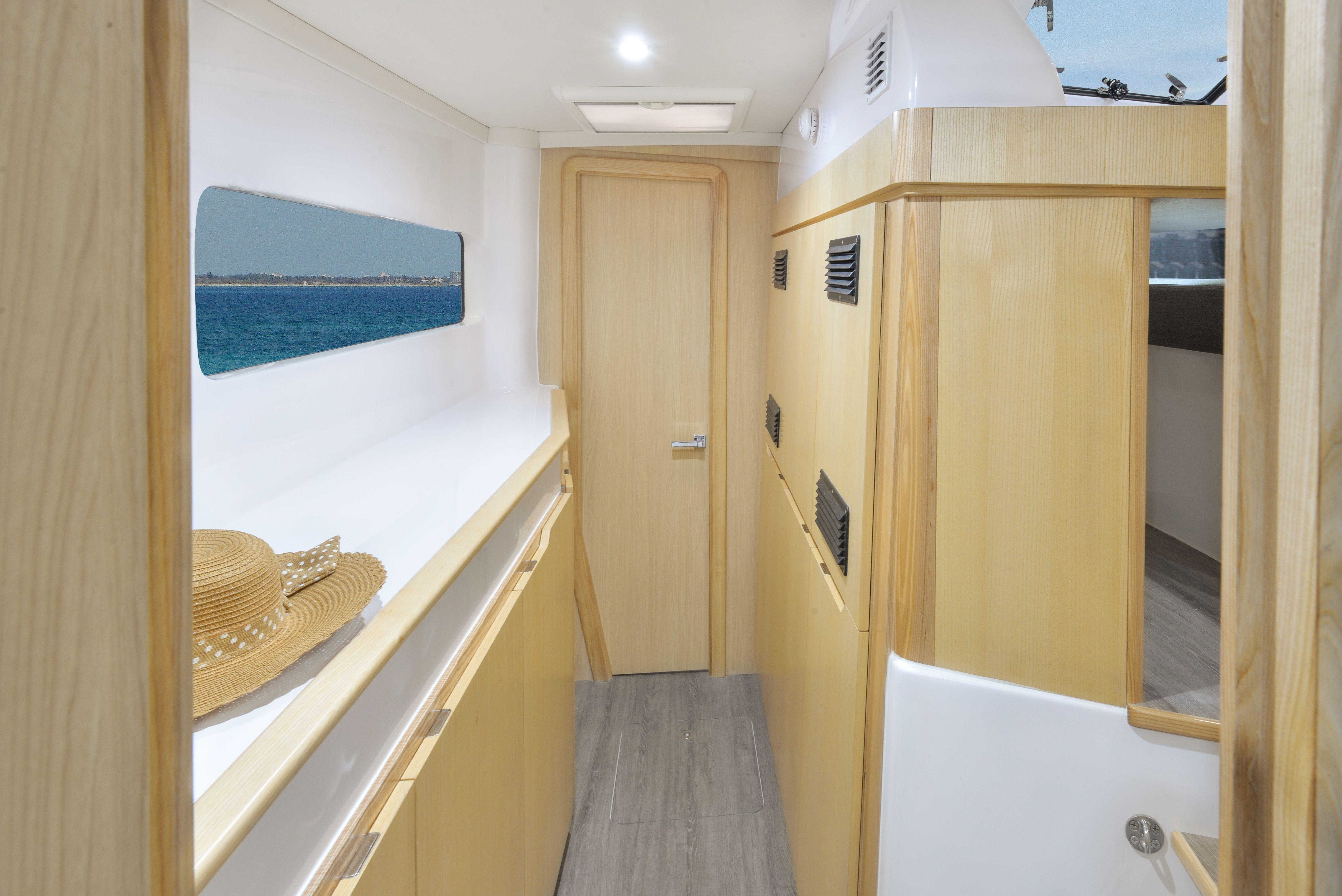 Interior of 2025 Seawind 1170 catamaran with wooden finishes and ocean view.