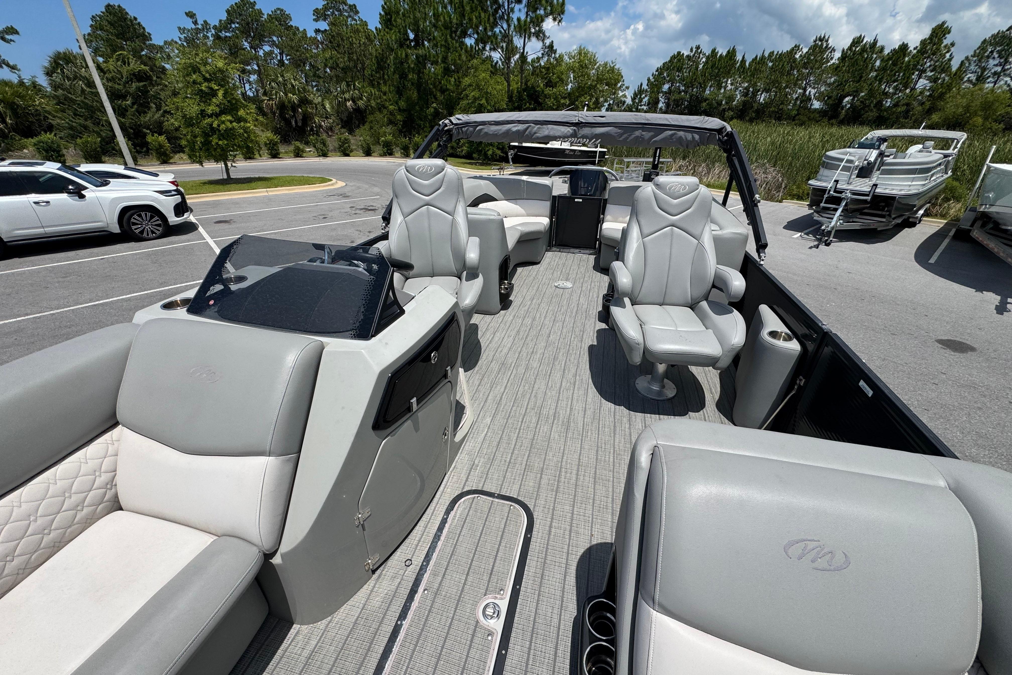 2022 Manitou 25 Encore pontoon boat with luxurious seating and modern design.