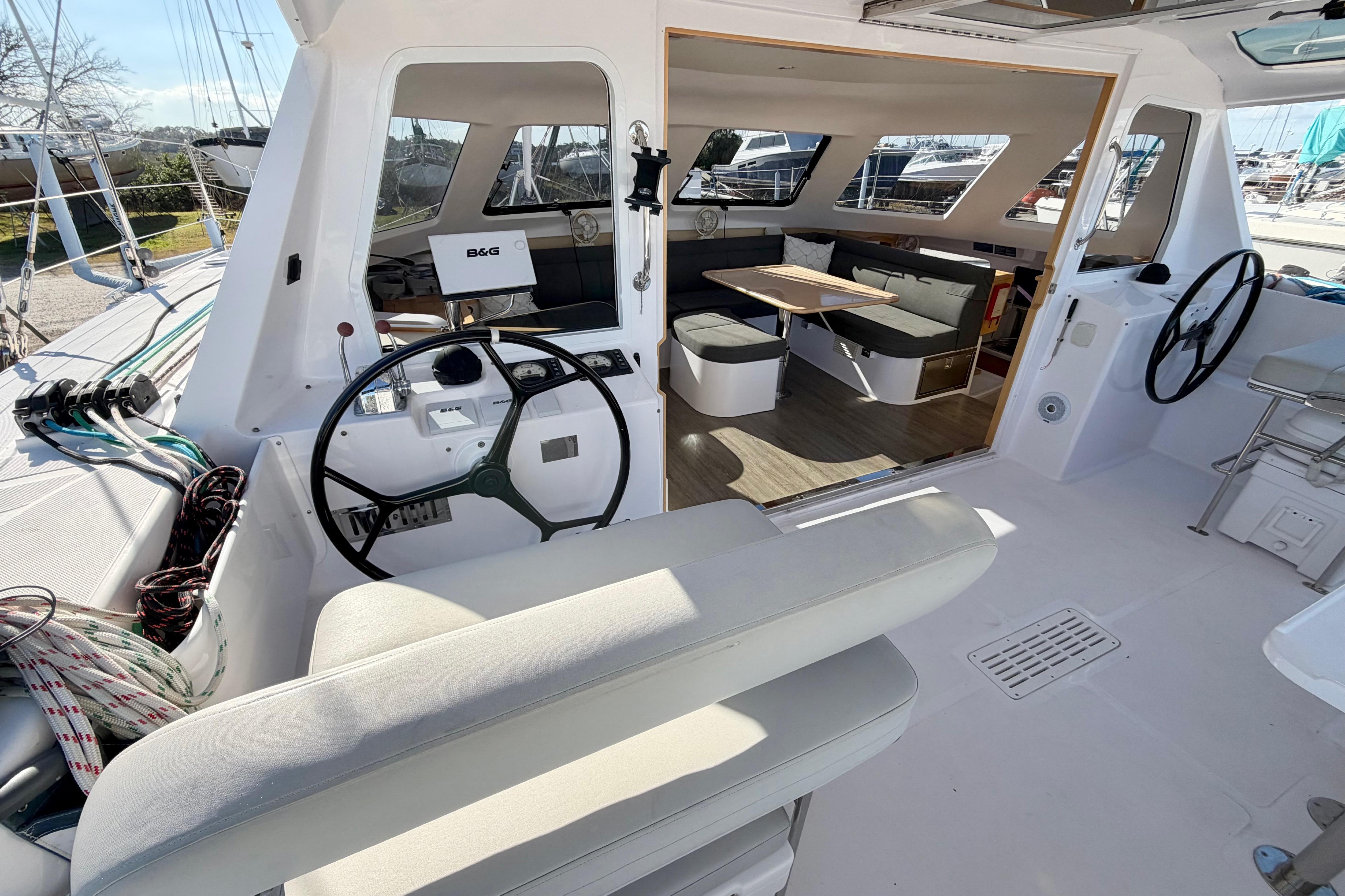 Interior view of 2020 Seawind 1260 catamaran, featuring helm and spacious seating area.