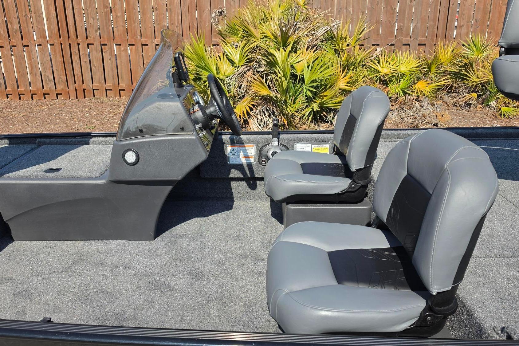 2026 Tracker Bass Tracker Classic XL boat interior with gray seats and steering console.